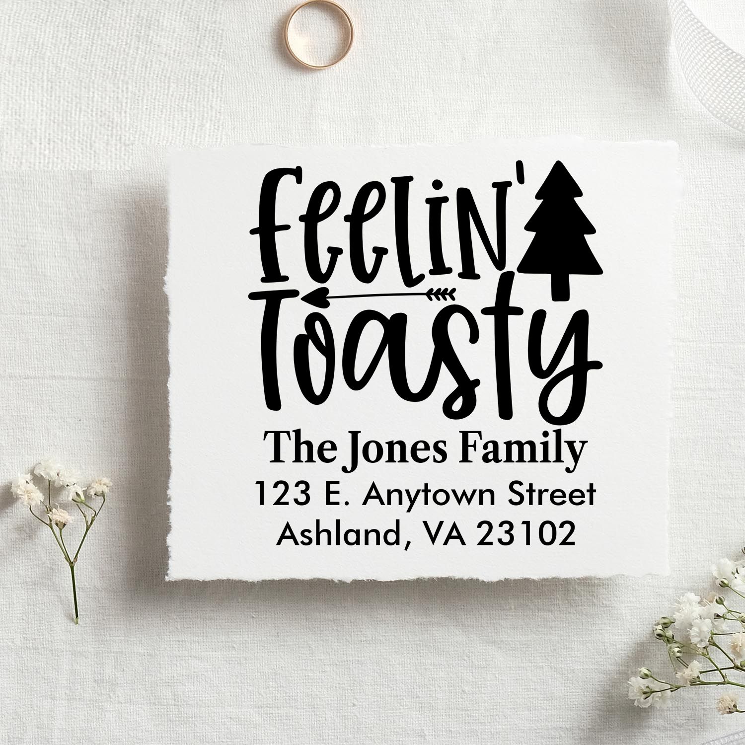 Custom Christmas rubber stamp with Fellin Toasty pine tree design, family name, and return address.