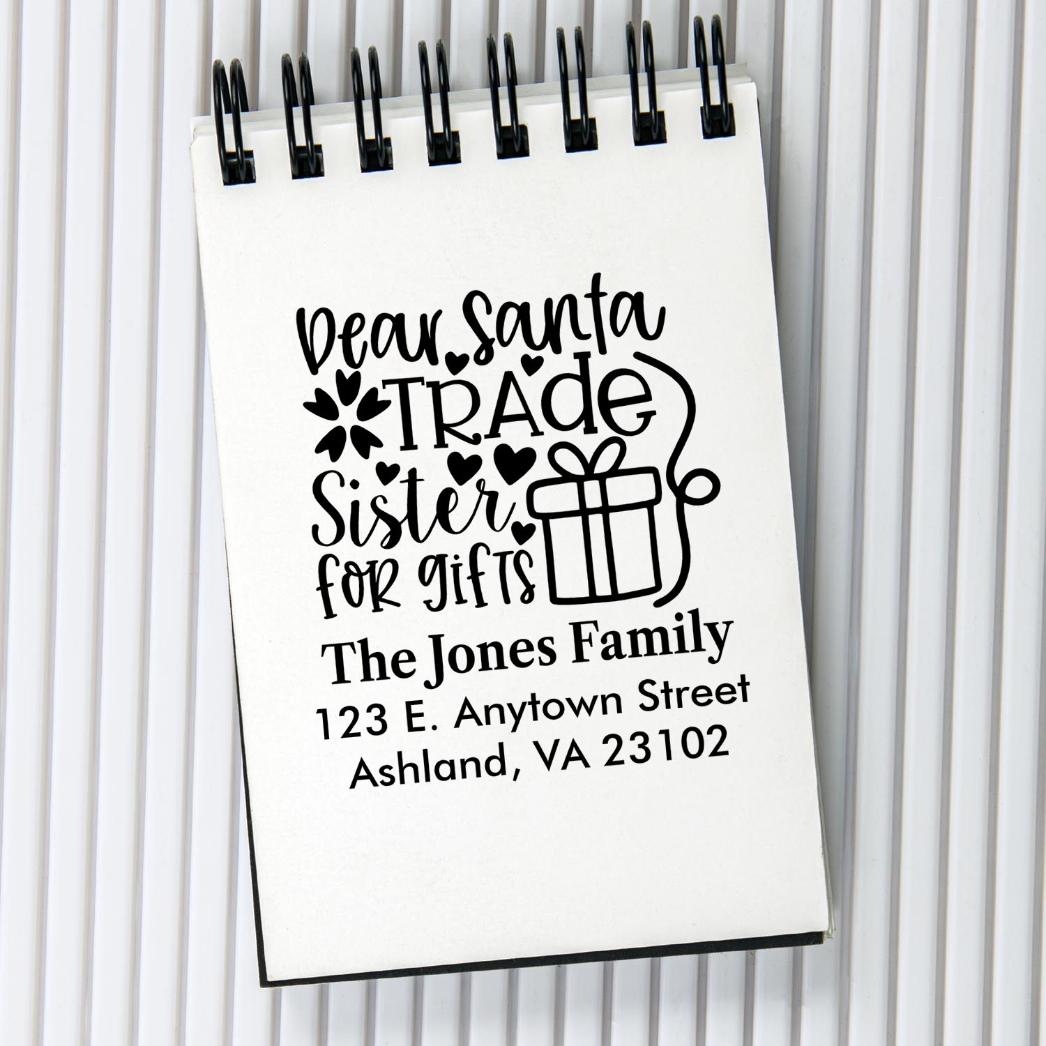 Custom holiday return address rubber stamp featuring Dear Santa, trade sister for gifts text, gift icon, and family address.