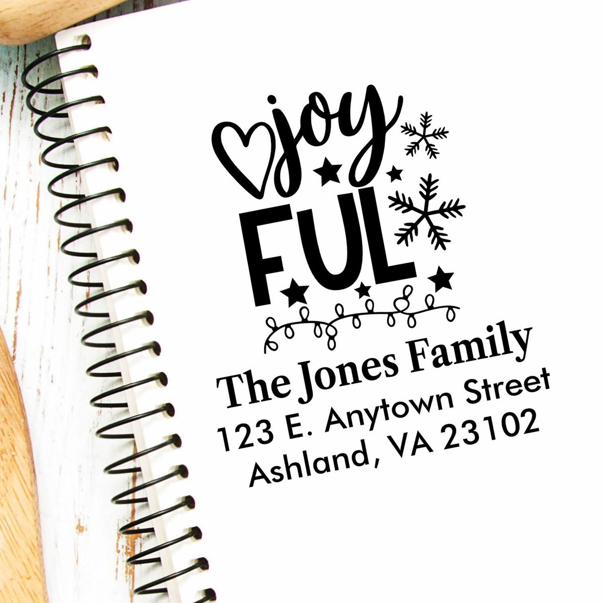 Personalized Christmas return address rubber stamp with Joyful holiday design, snowflakes, stars, and family name.