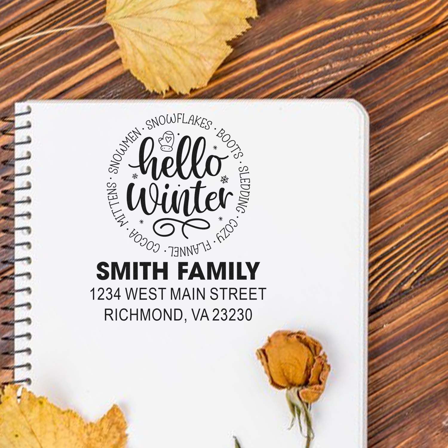 Personalized Hello Winter address rubber stamp design with Smith family return address on notebook.
