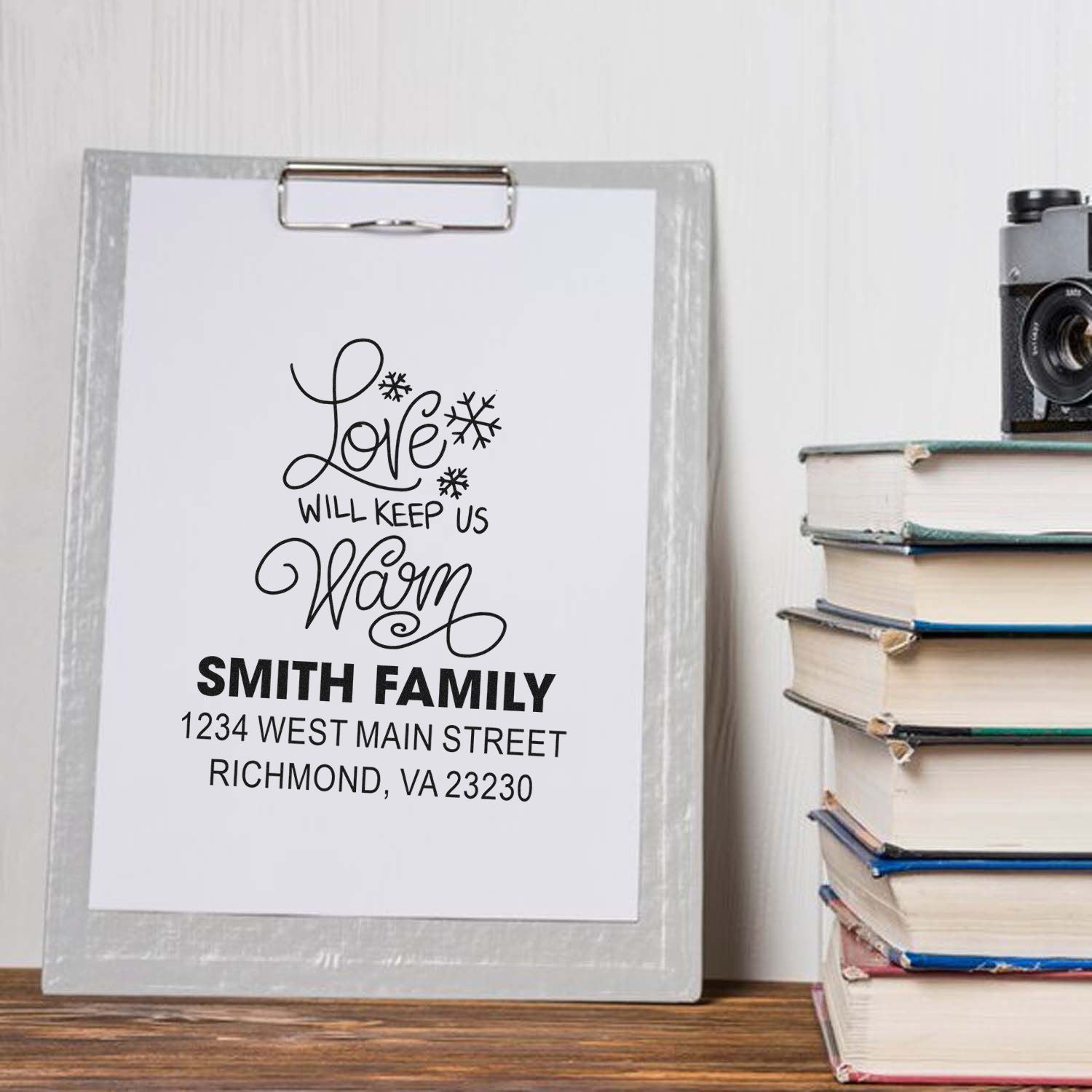 Custom return address rubber stamp with Love Will Keep Us Warm quote and Smith family address for personalized mail.