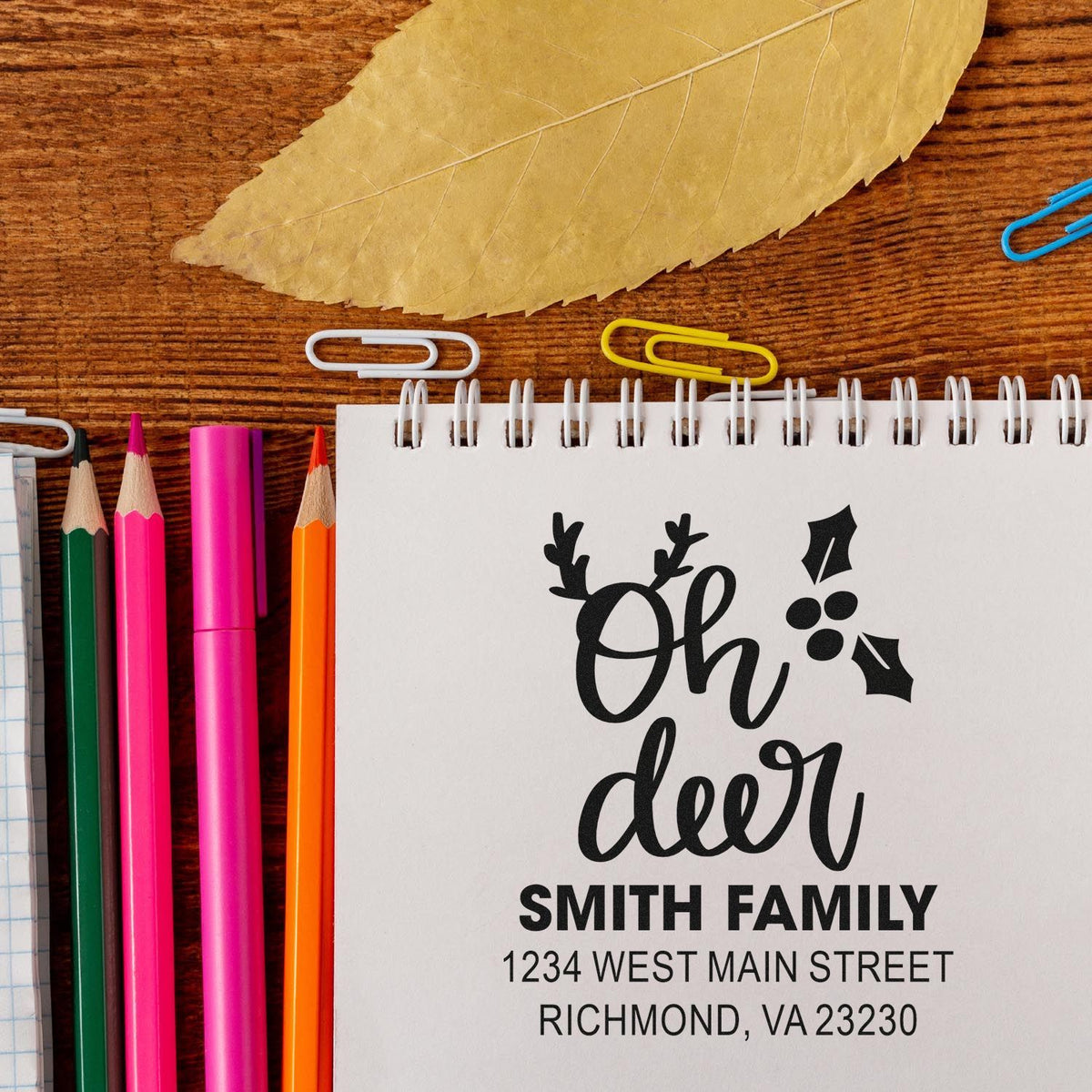 Custom holiday rubber stamp design with Oh deer, Smith Family name and return address on a notebook.