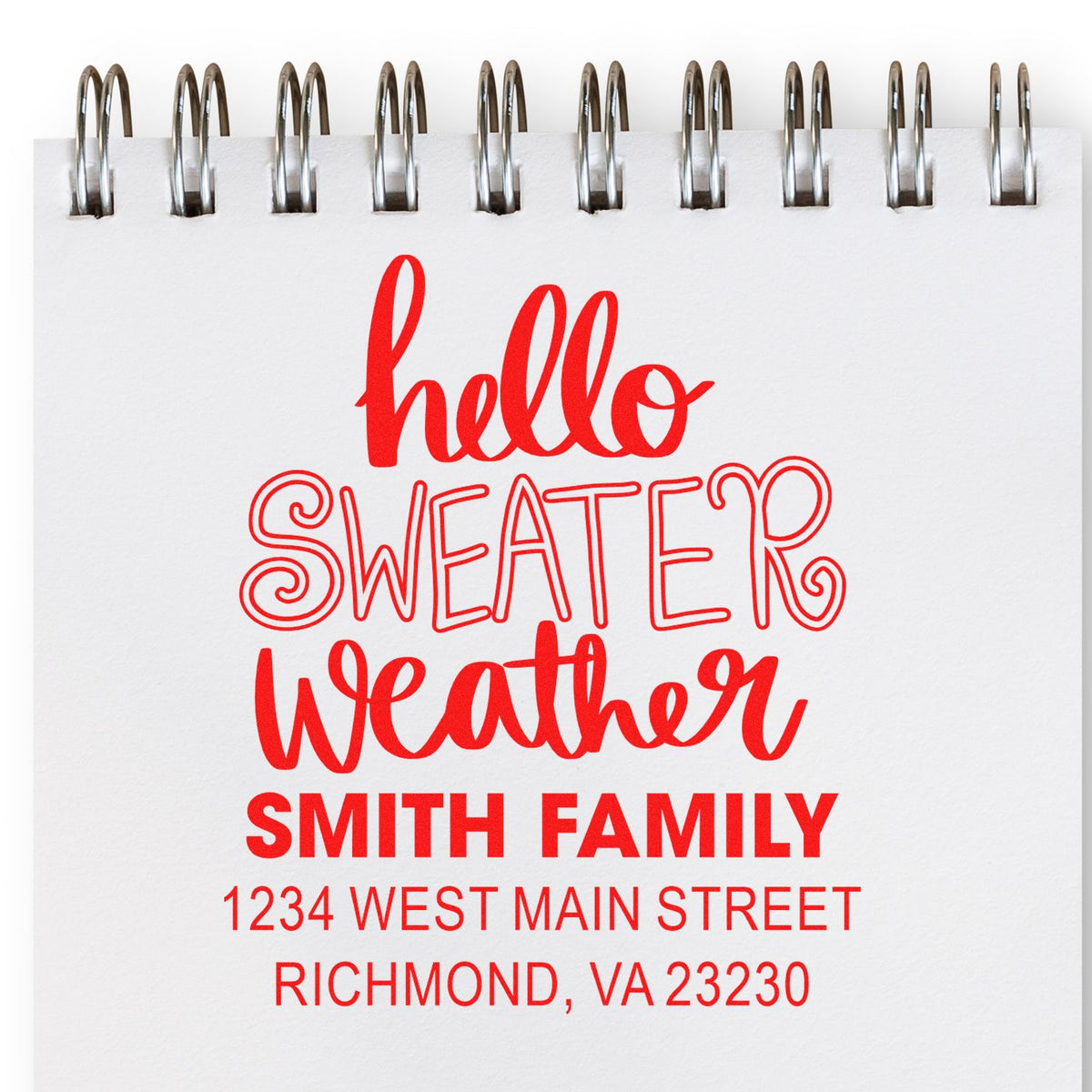 Custom address rubber stamp with hello sweater weather for Smith Family, shown on a notepad.