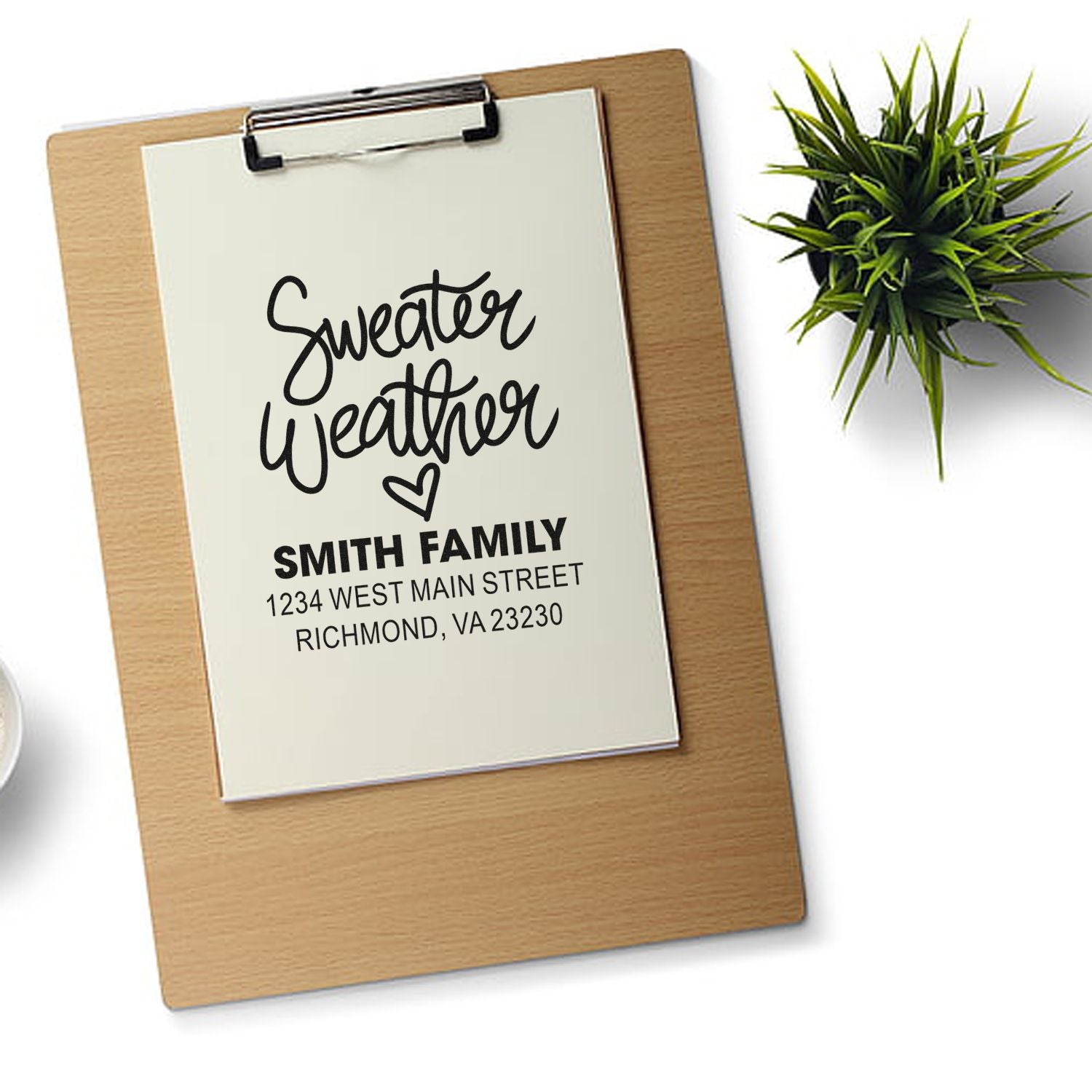 Personalized family address rubber stamp design with Sweater Weather script, Smith Family name, and return address on clipboard.