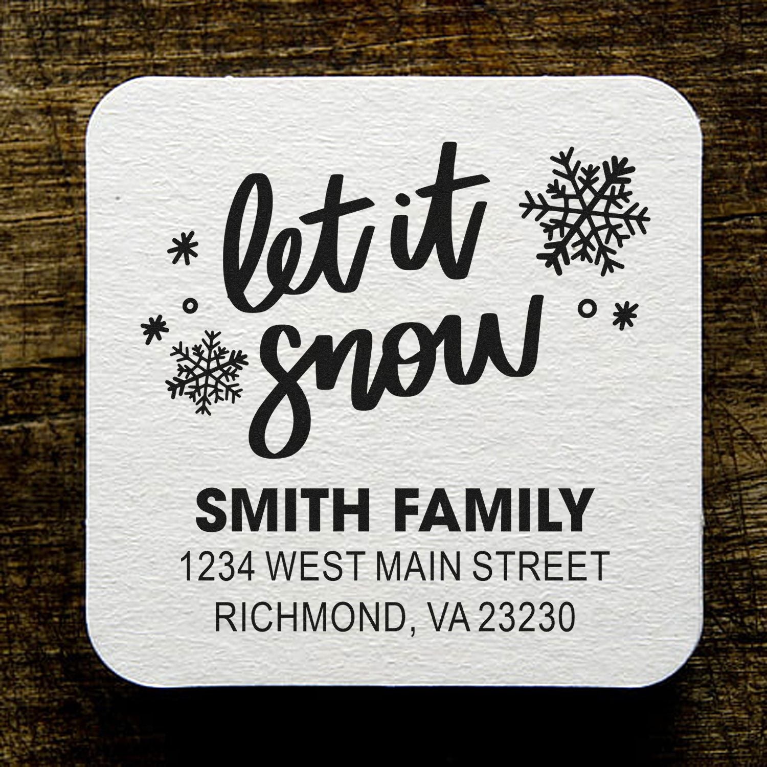 Custom Let It Snow return address rubber stamp for Smith Family holiday mail, with name, street address, and snowflakes.