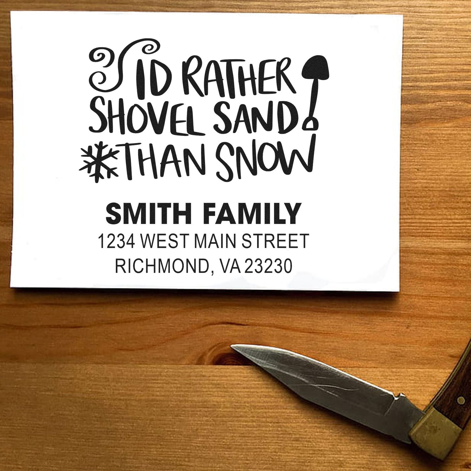 Custom rubber stamp sample with Id rather shovel sand than snow and Smith Family return address for winter holiday cards.