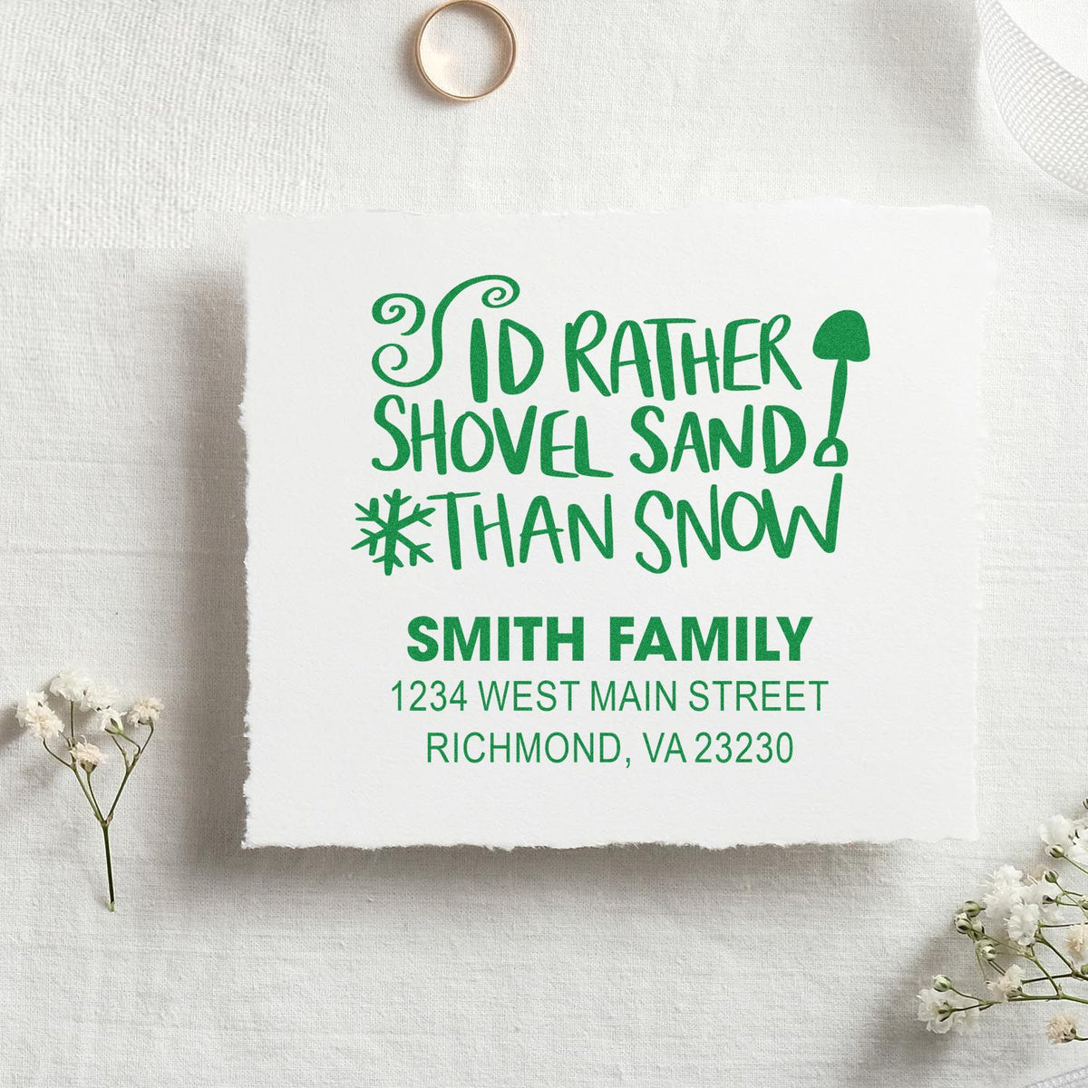 Personalized rubber stamp with holiday phrase Id rather shovel sand than snow and Smith family return address.
