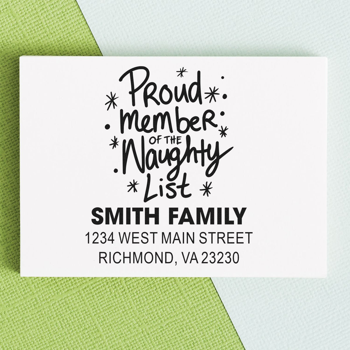 Personalized holiday address rubber stamp with Proud Member of the Naughty List for Smith family envelopes.