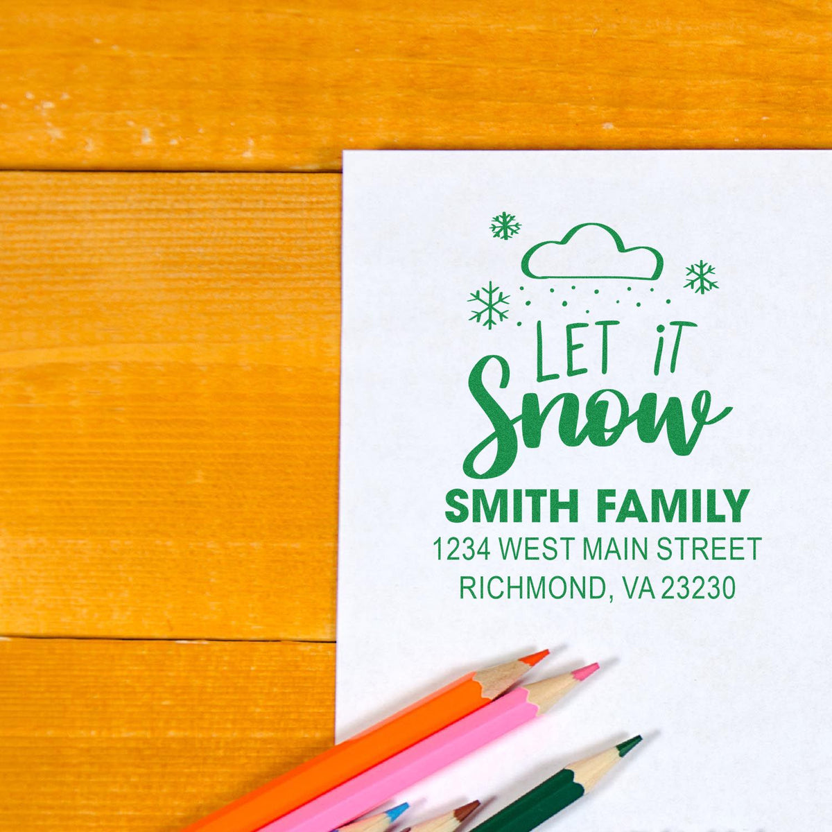 Personalized holiday return address rubber stamp with Let It Snow design, family name, and mailing address.