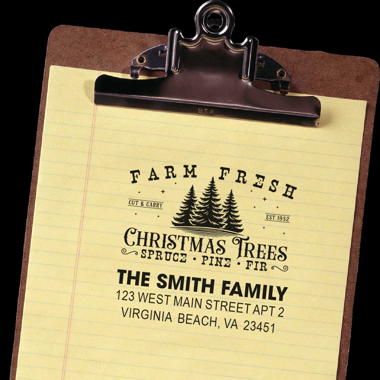 Personalized rubber stamp sample with Farm Fresh Christmas Trees logo and family address on clipboard.