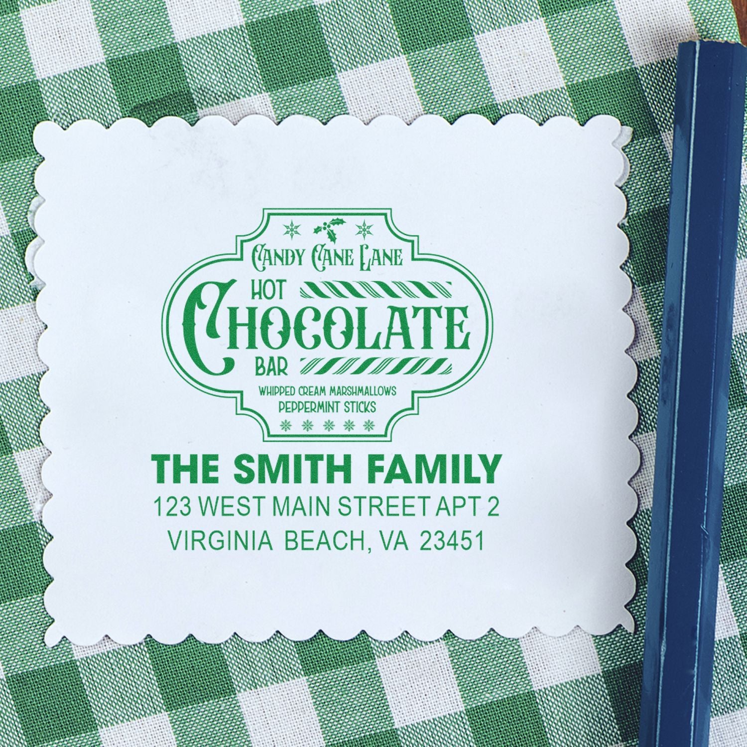 Custom rubber stamp for hot chocolate bar packaging with festive candy cane design, family name, and address