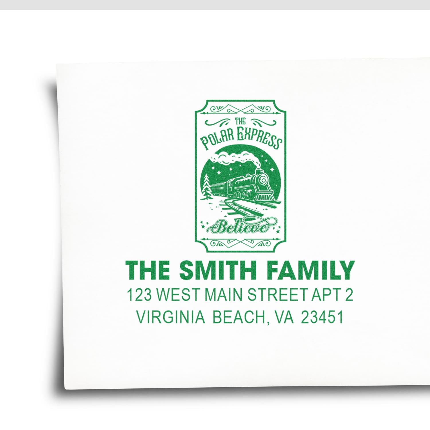 Custom holiday return address rubber stamp with Polar Express Believe train design for The Smith Family in green.