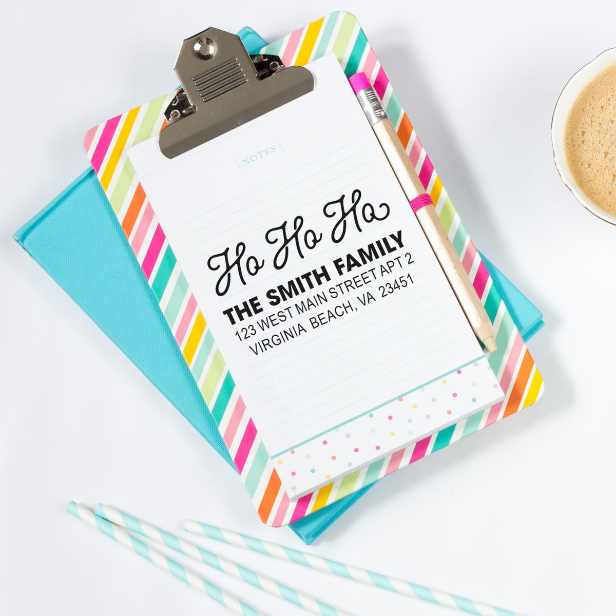 Custom return address rubber stamp on a festive clipboard notepad, ideal for holiday cards and mailing labels.