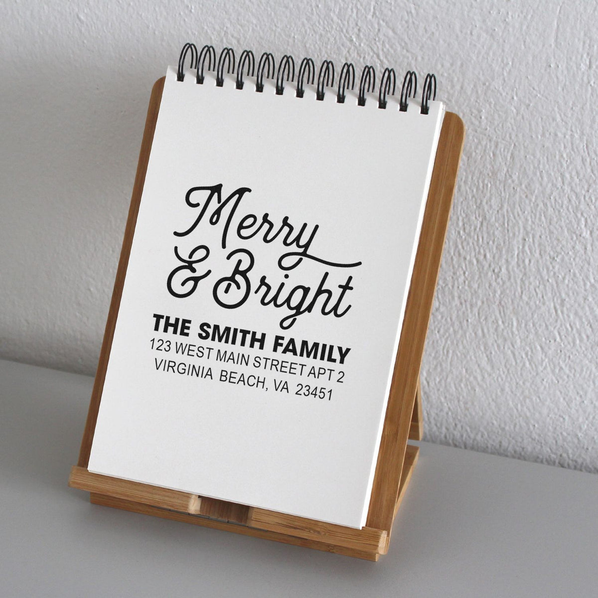 Custom Merry & Bright holiday address rubber stamp with The Smith Family name and Virginia Beach address.