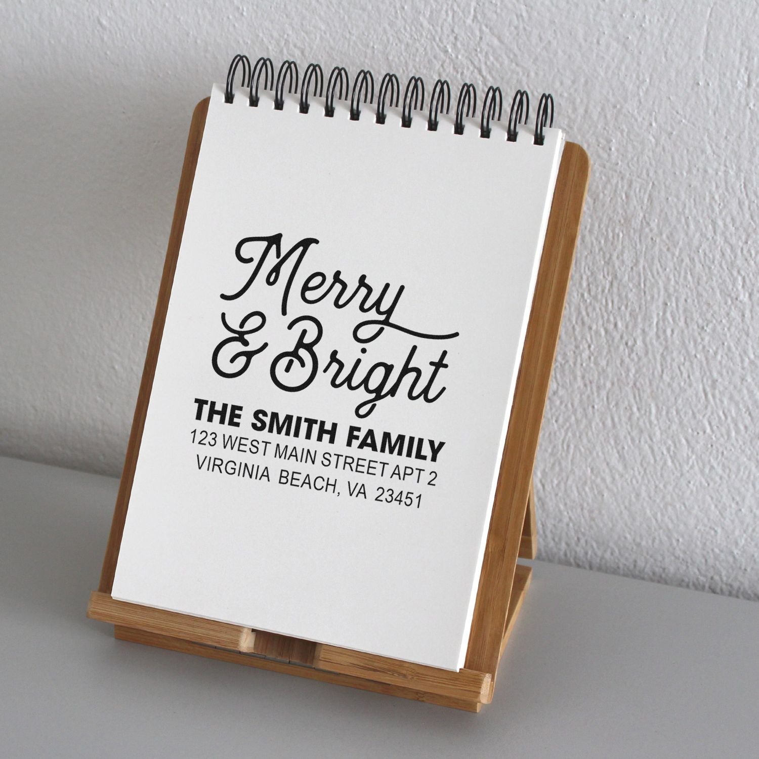 Custom holiday address stamp design with Merry & Bright greeting and family return address for Christmas cards.