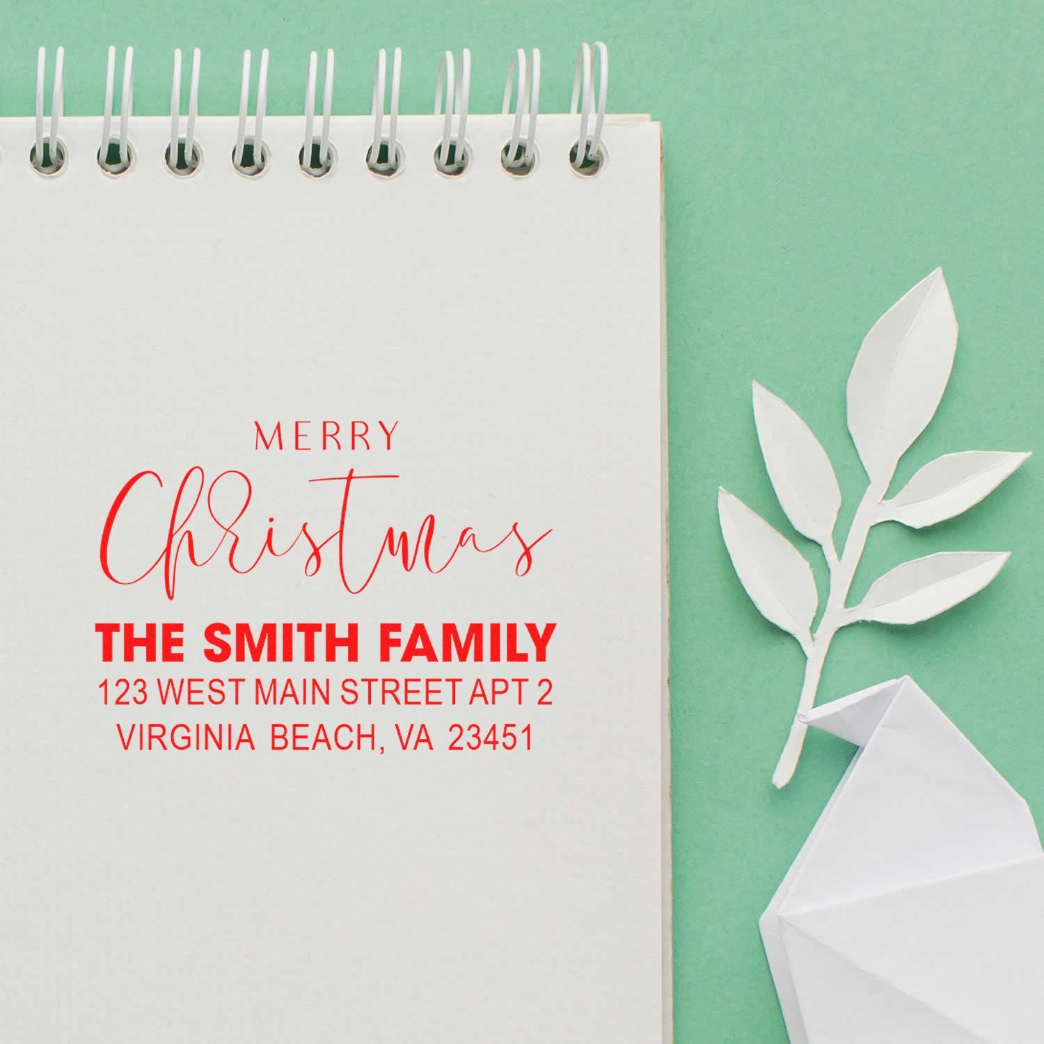 Custom Merry Christmas address rubber stamp for The Smith Family, shown as a holiday return-address notebook mockup.