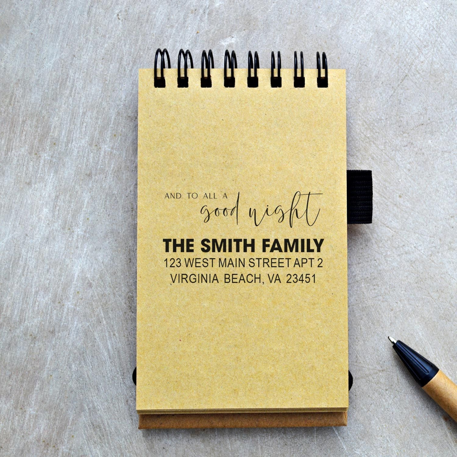 Custom address rubber stamp on a notebook with and to all a good night and The Smith Family return address.