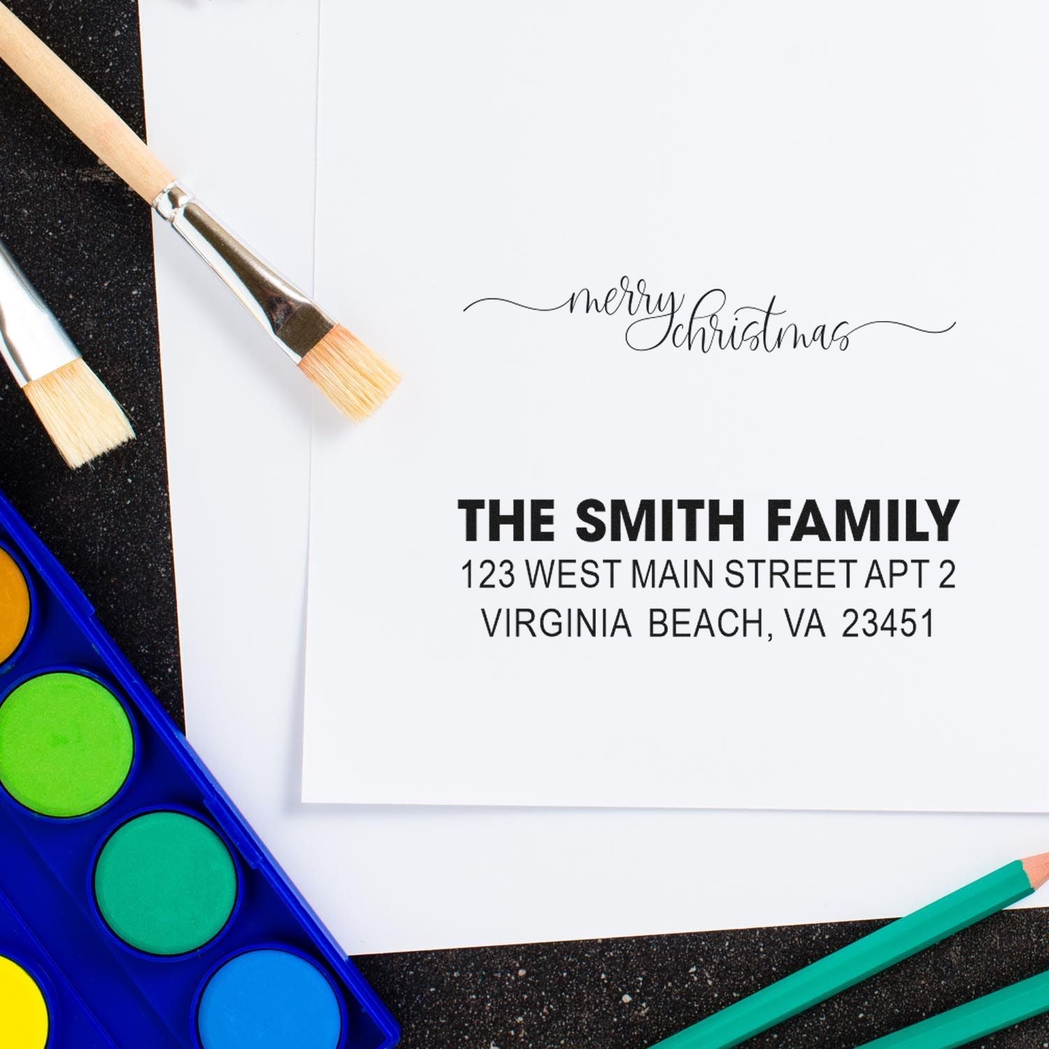 Custom Merry Christmas return address rubber stamp for holiday cards, featuring family name and address.