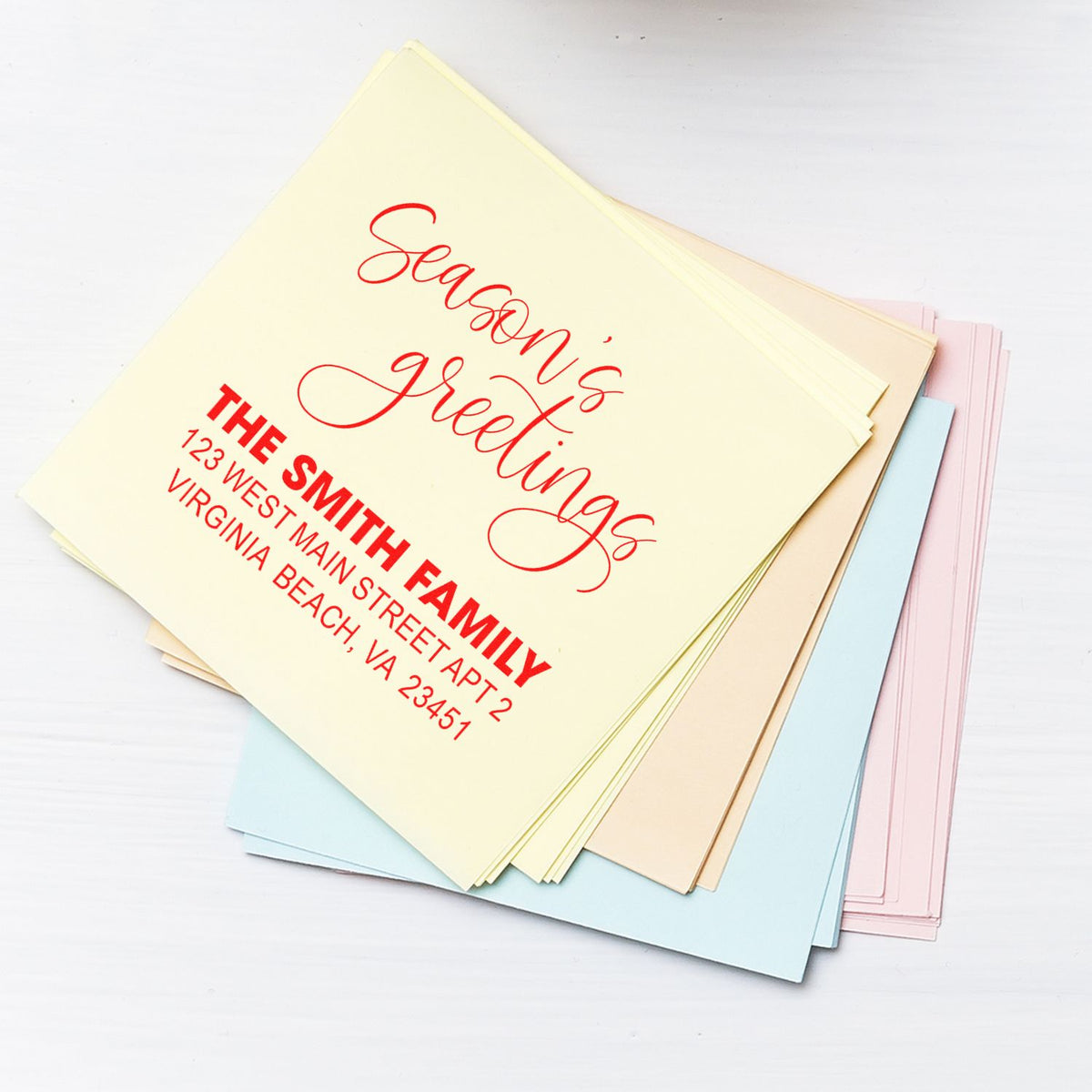Custom holiday rubber stamp with Seasons Greetings and return address for personalized cards.