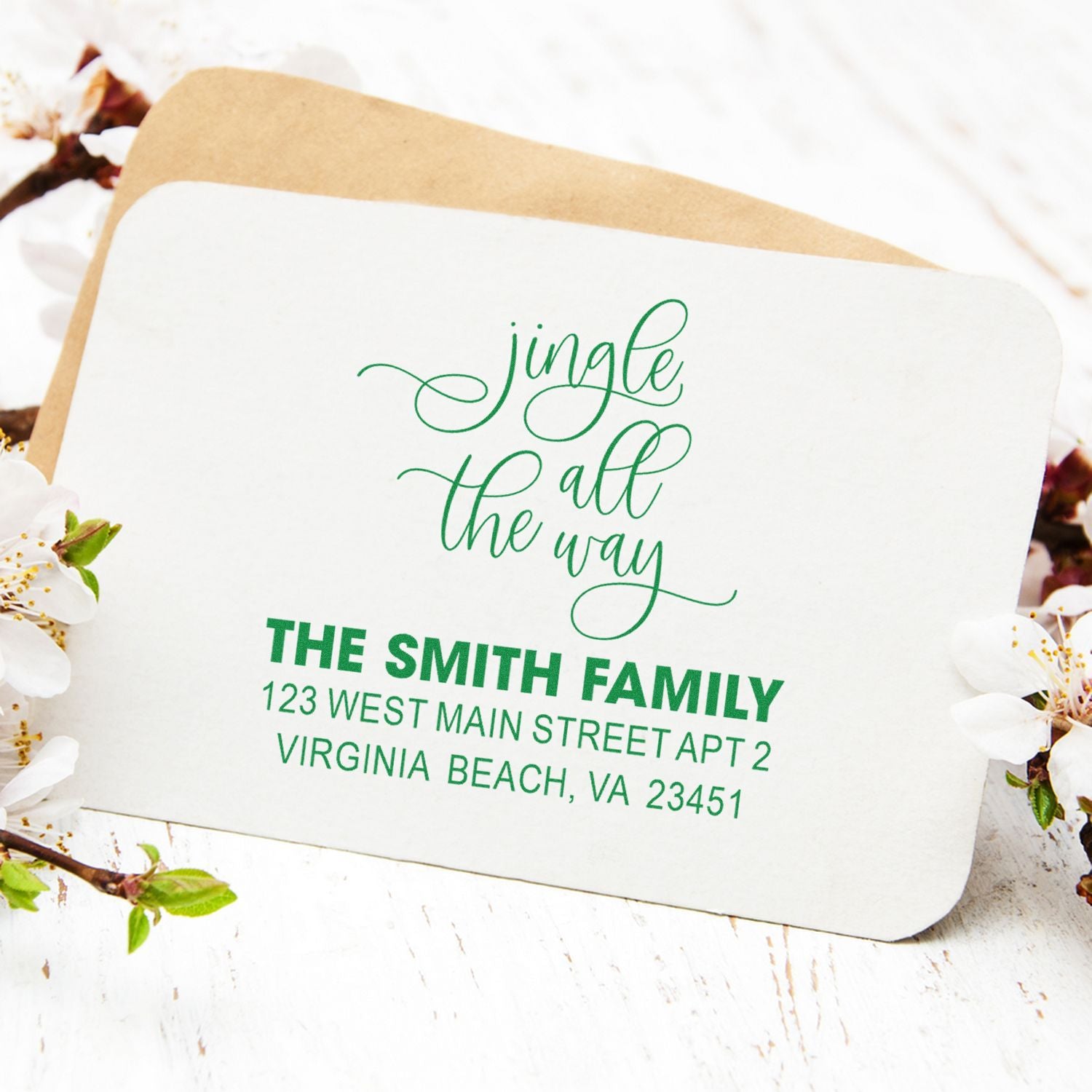Personalized holiday rubber stamp with Jingle all the way and return address for festive Christmas envelopes.