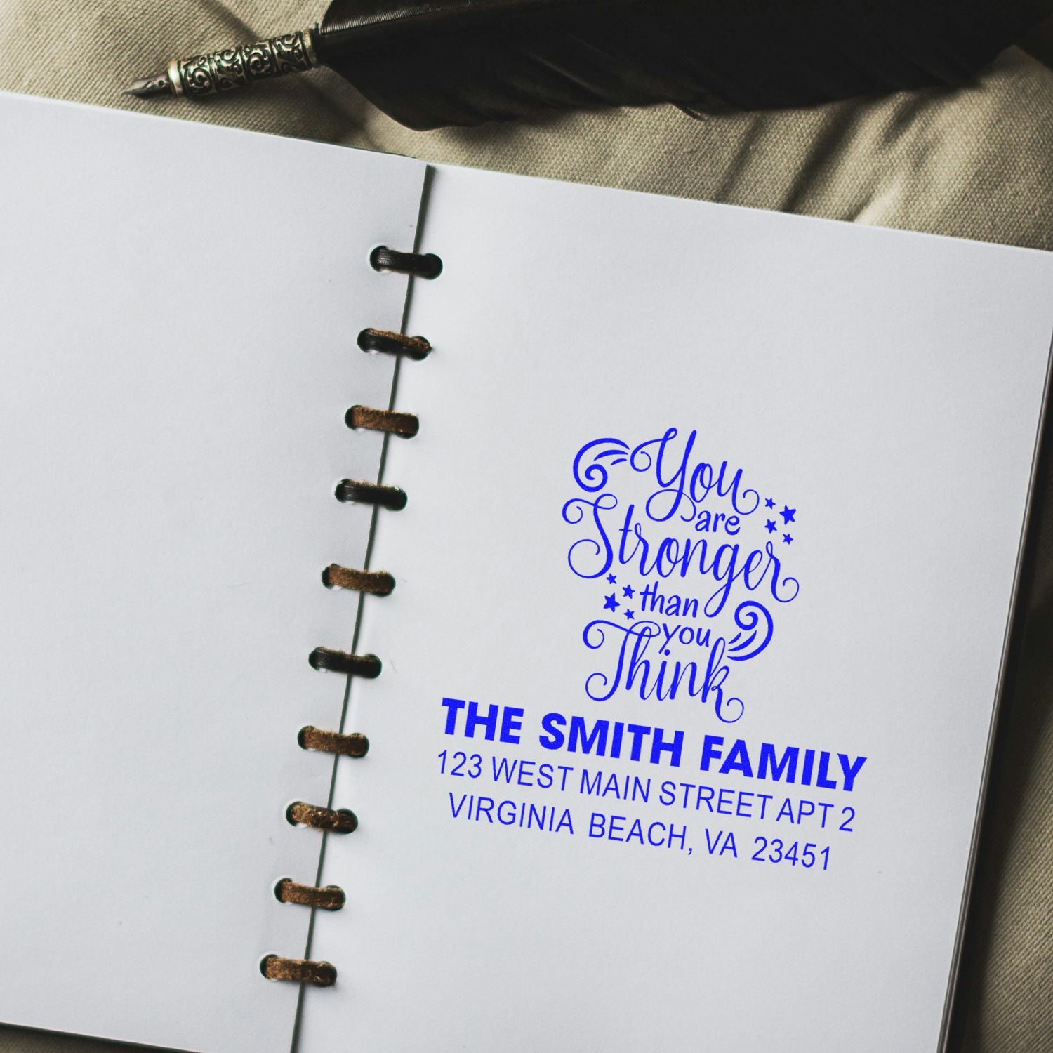 Personalized rubber stamp impression on notebook page with inspirational quote and return address for The Smith Family.