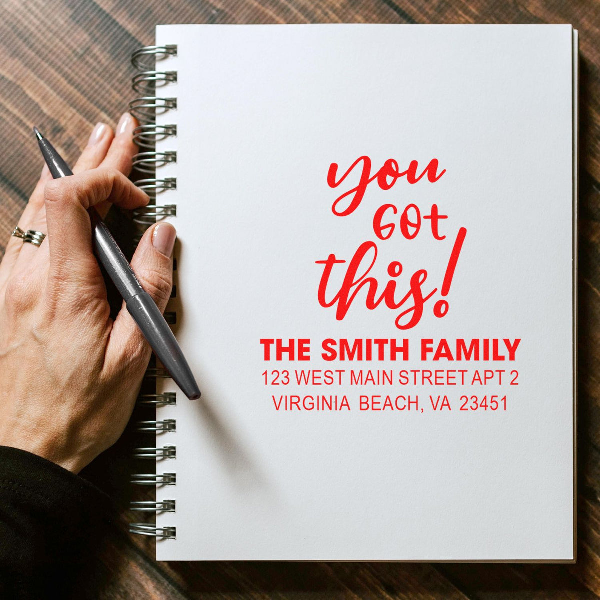 Custom rubber stamp reading you got this! with The Smith Family return address on a notebook page.