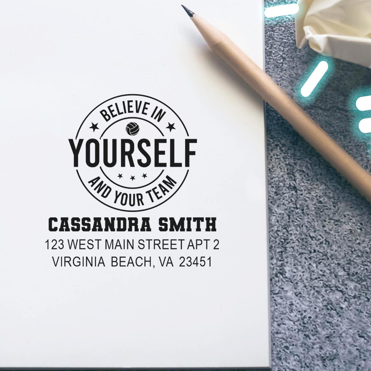 Personalized rubber stamp design with Believe in Yourself and Your Team, name, and address for custom business use.