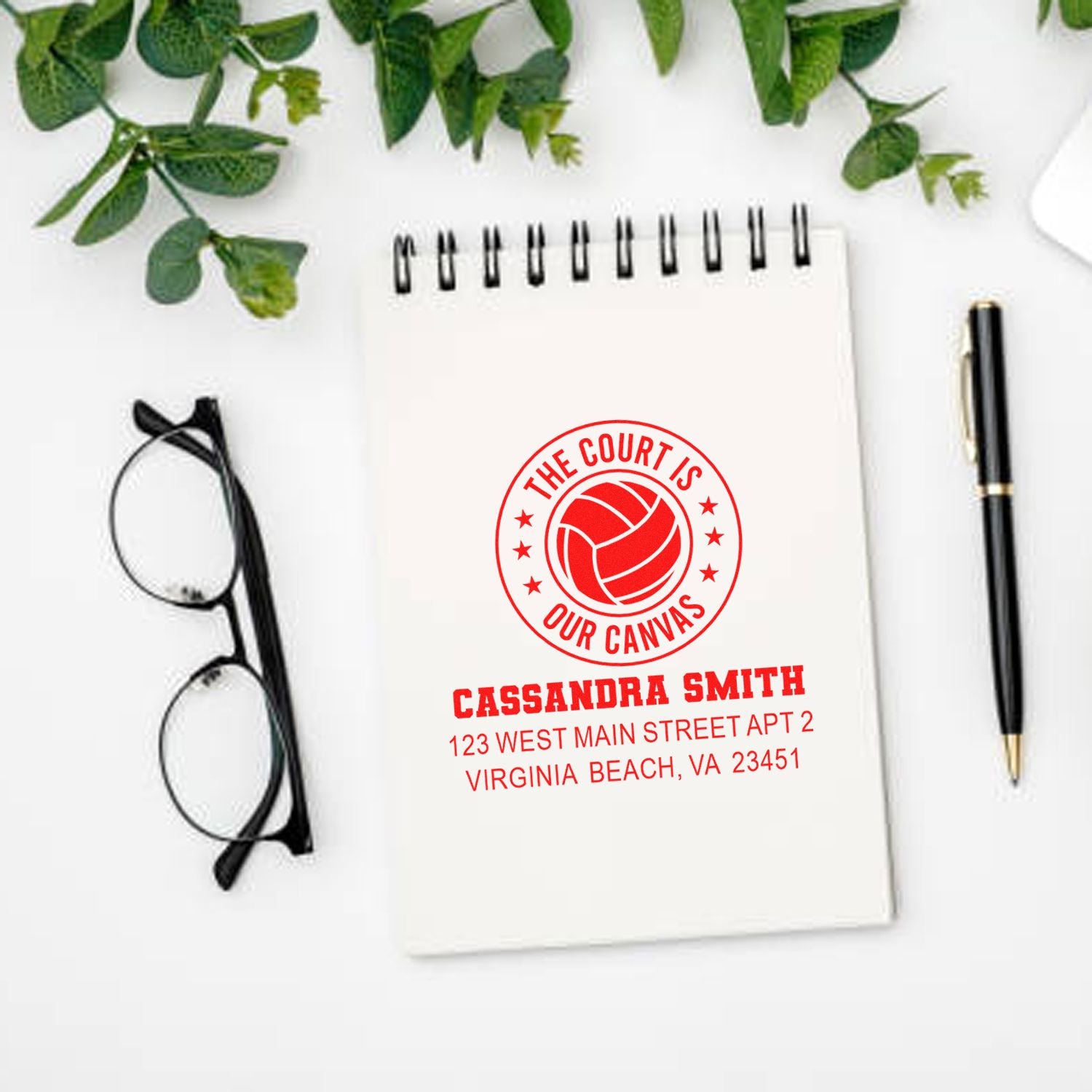 Personalized volleyball rubber stamp with name and address, shown on notebook mockup for custom sports-themed stationery.