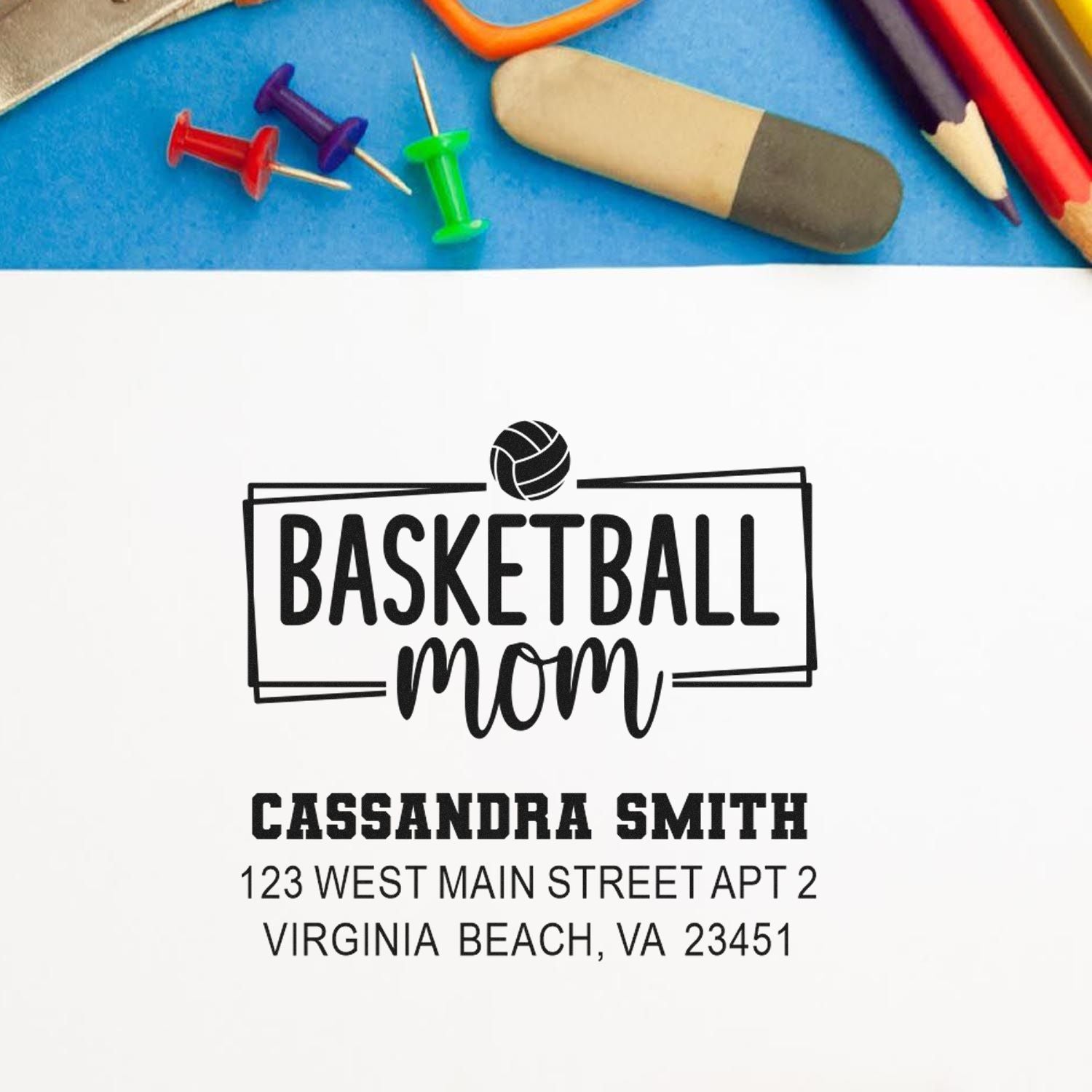 Personalized basketball mom rubber stamp with name and address, shown with stamping tools and pencils.
