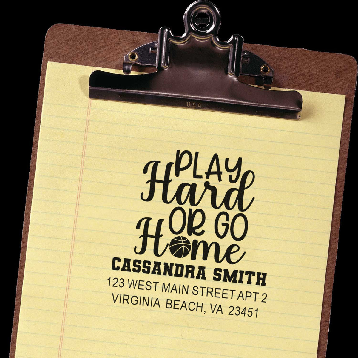 Custom rubber address stamp impression on clipboard with Play Hard or Go Home, name, and return address.
