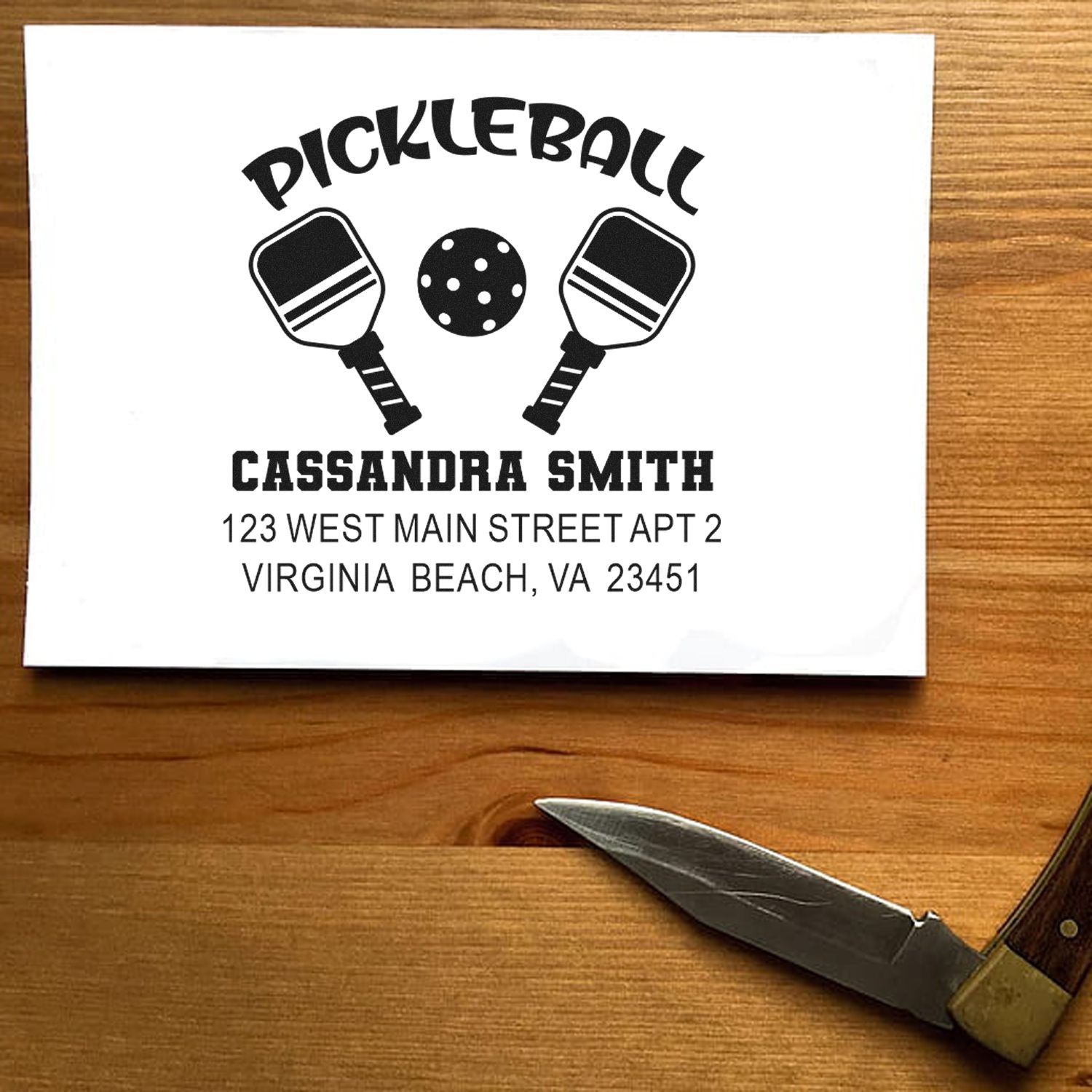 Personalized pickleball rubber stamp with paddles and ball, featuring name and address for custom mailing.