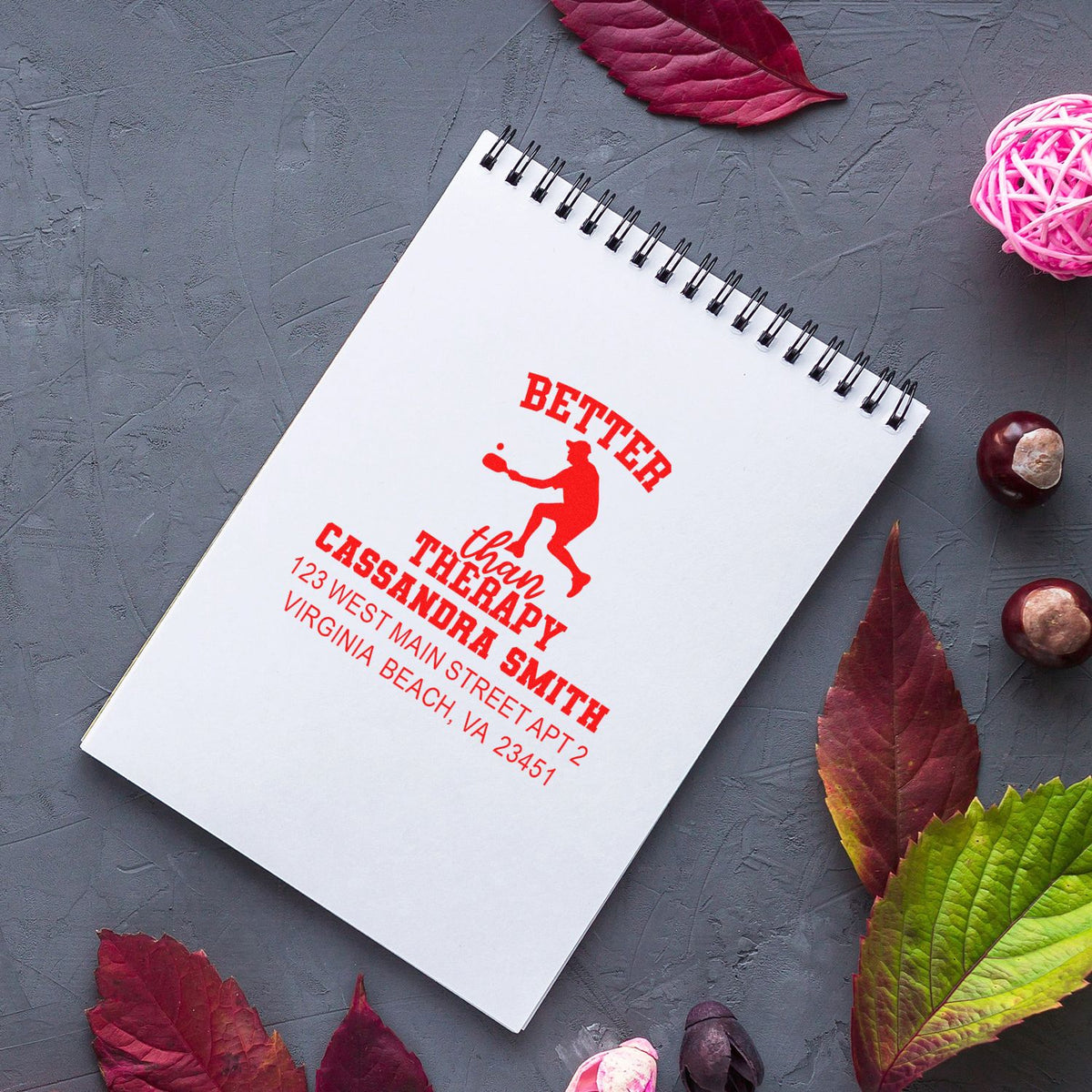 Custom rubber stamp impression on notebook reading Better Than Therapy with therapist name and address design.