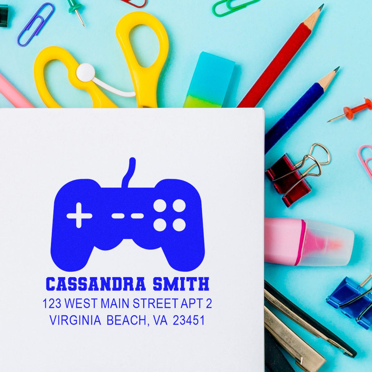 Personalized custom rubber stamp return address with game controller logo for Cassandra Smith on stationery.