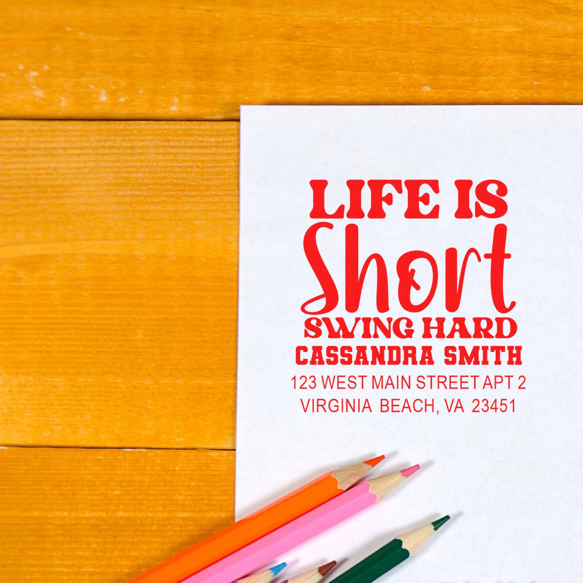 Custom address rubber stamp with Life Is Short, Swing Hard on a white envelope
