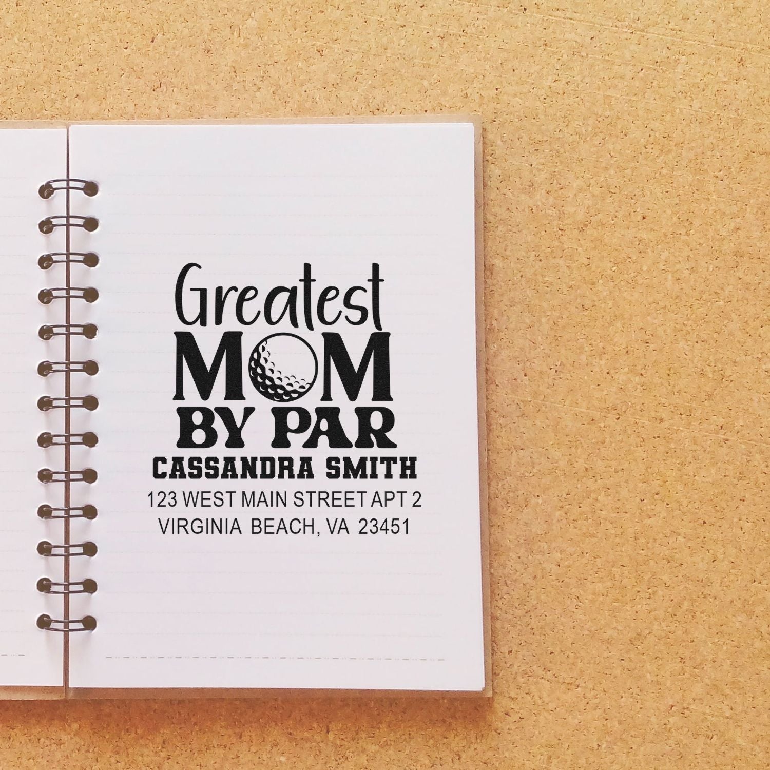 Custom rubber stamp design: Greatest Mom by Par with name and address, shown on a notebook mockup.