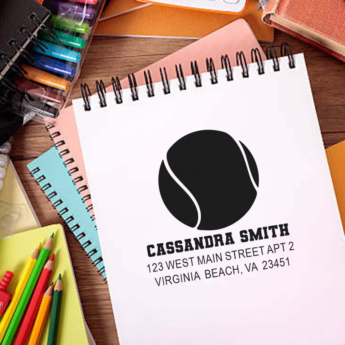 Custom return address rubber stamp with tennis ball logo for personalized stationery and mailings.