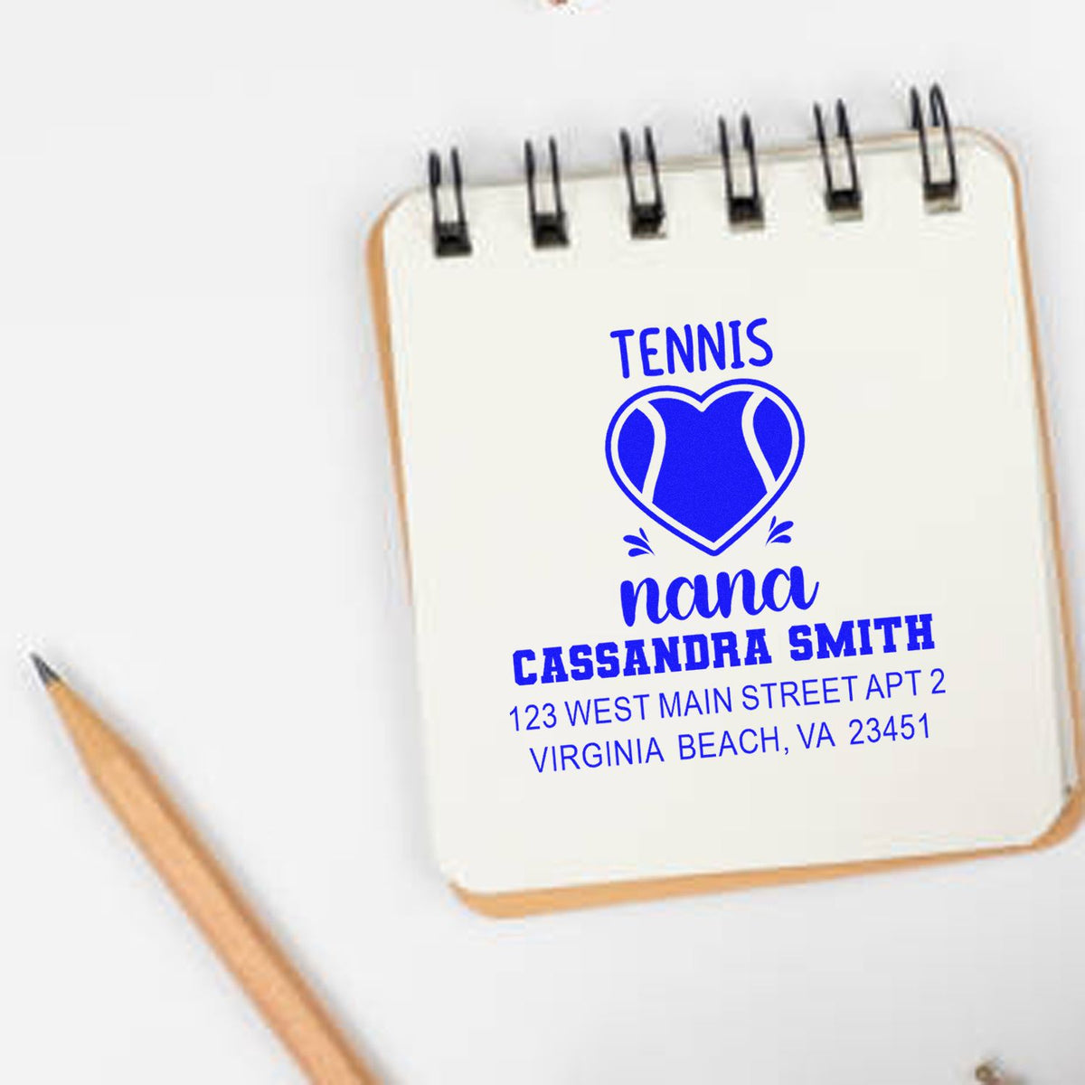 Personalized tennis return address rubber stamp with heart design, featuring name and address for stationery and gift packaging.