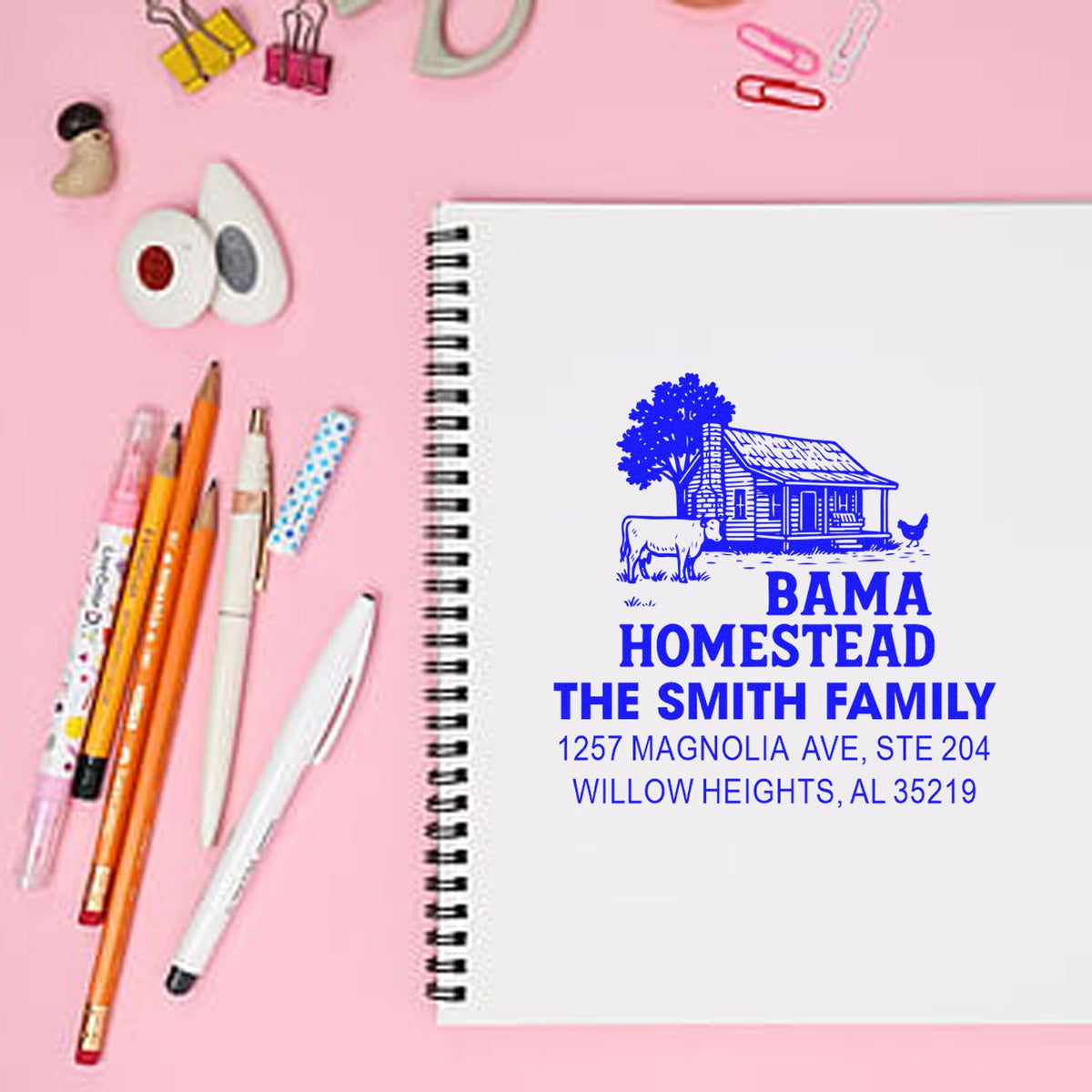 Personalized family address rubber stamp with farmhouse homestead design, shown stamped on a notebook.