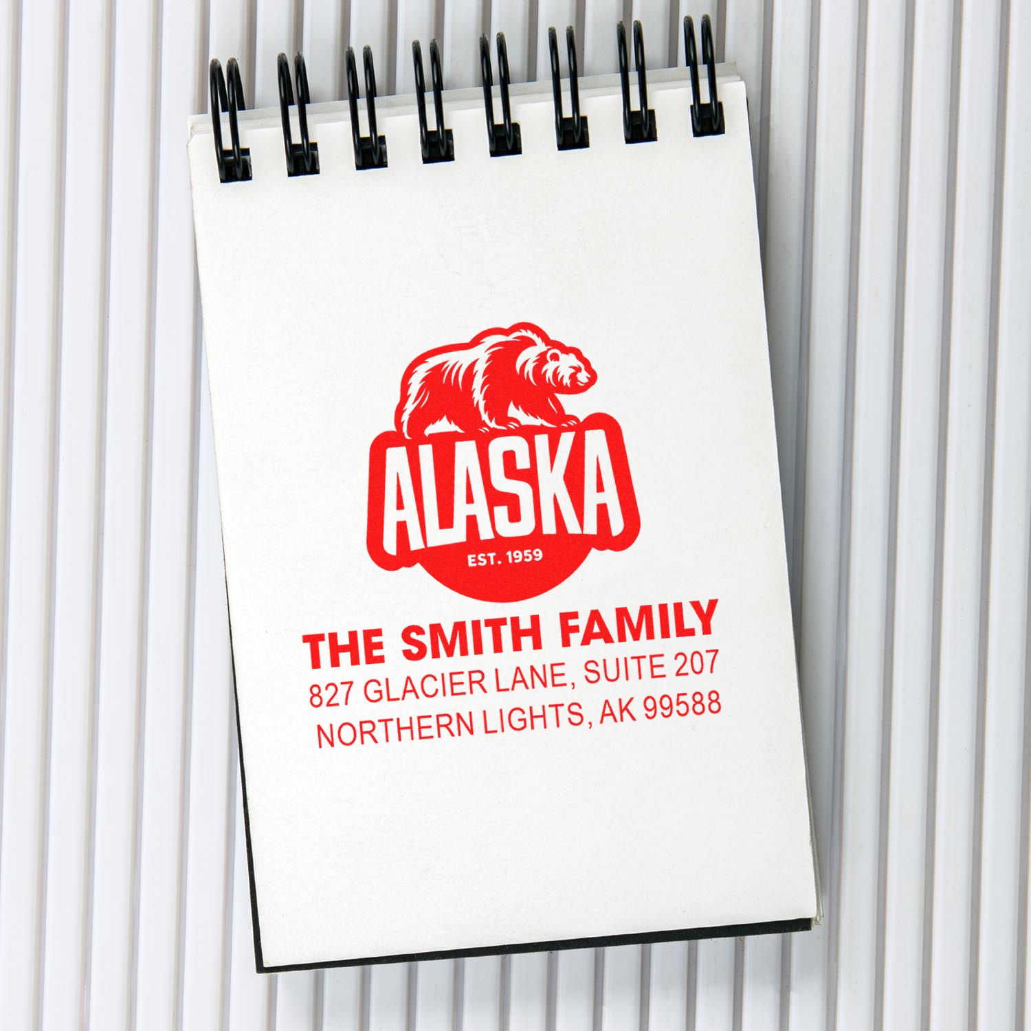 Custom Alaska address rubber stamp with bear logo, The Smith Family name, and return address in red.