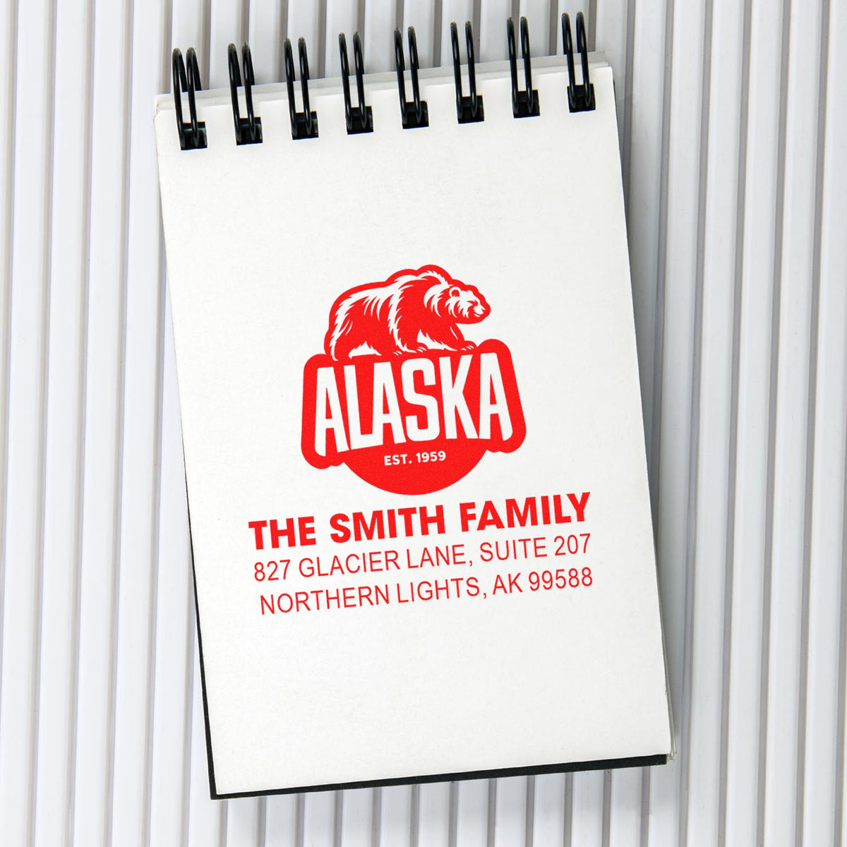 Personalized Alaska bear family address rubber stamp design with Smith family name and mailing address on a spiral notebook.