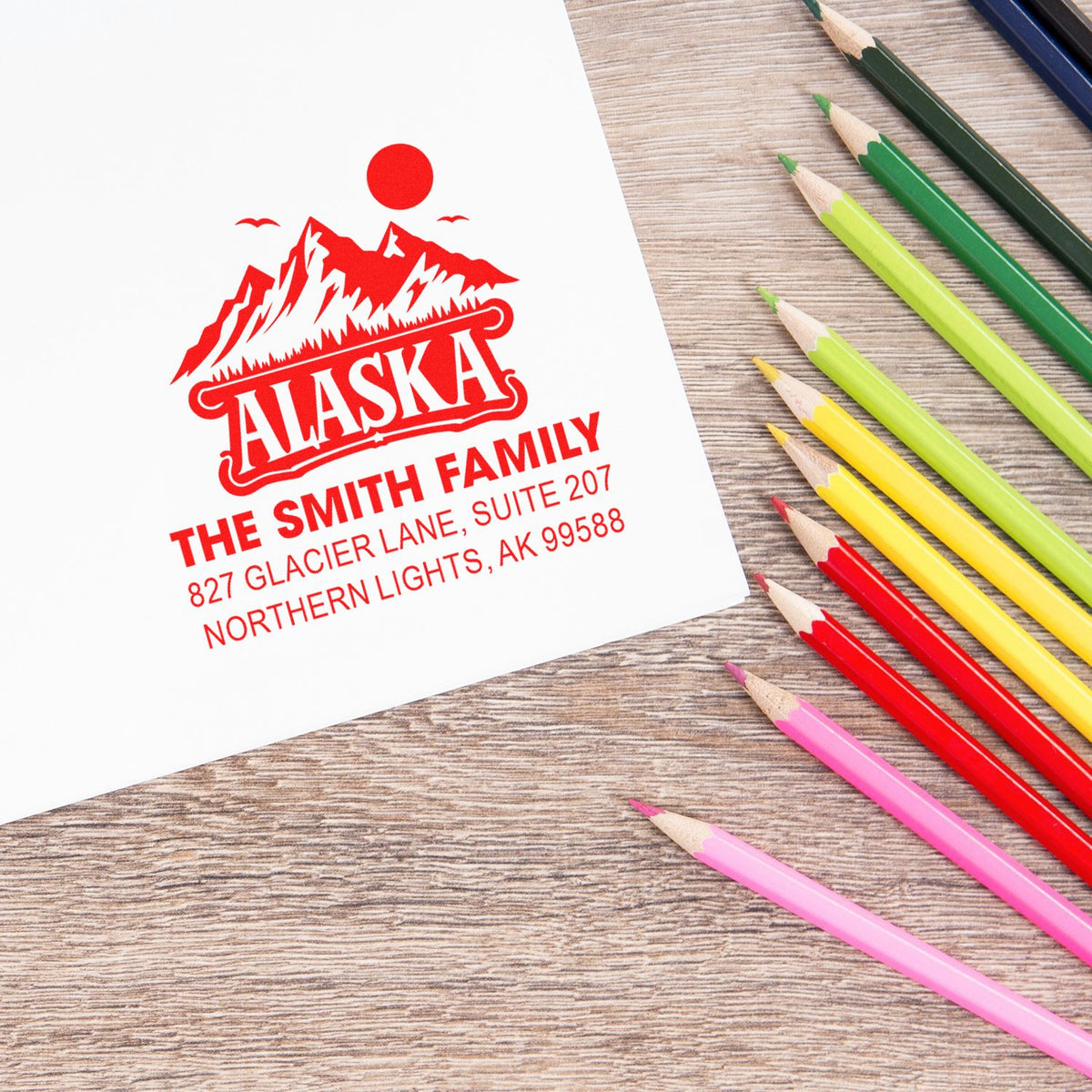 Custom Alaska return address rubber stamp with family name and address for personalized envelope labeling.