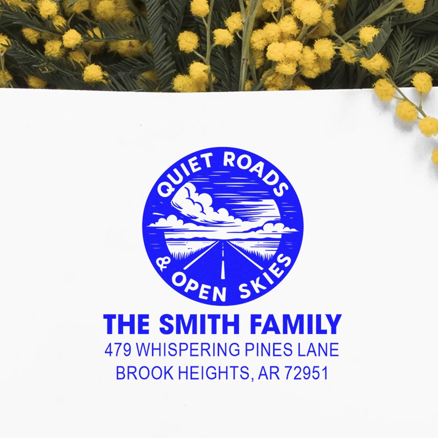 Custom rubber address stamp for The Smith Family with Quiet Roads & Open Skies logo and Brook Heights, AR return address.