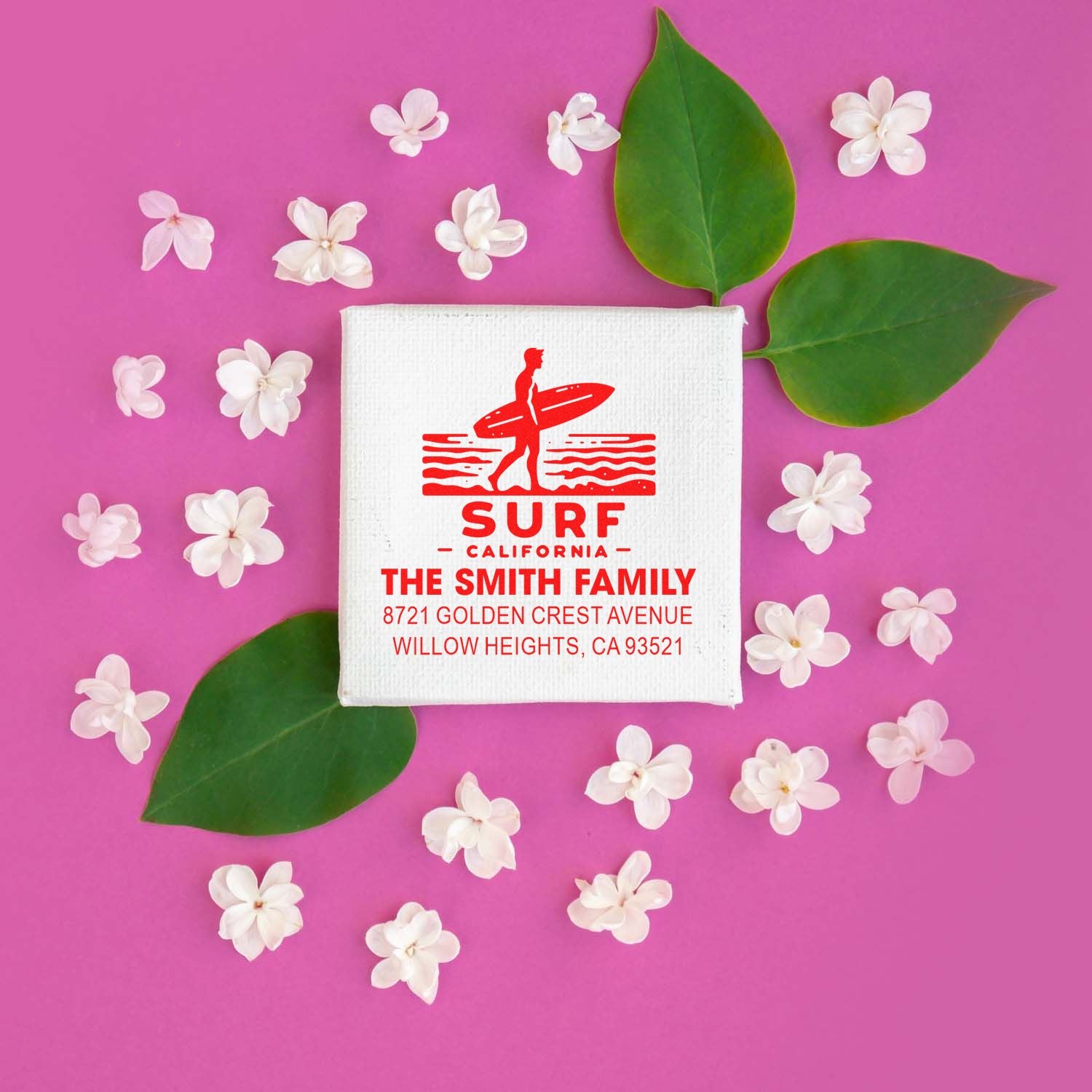 Custom surf rubber stamp with family name and return address, featuring a California beach design on a pink floral background.