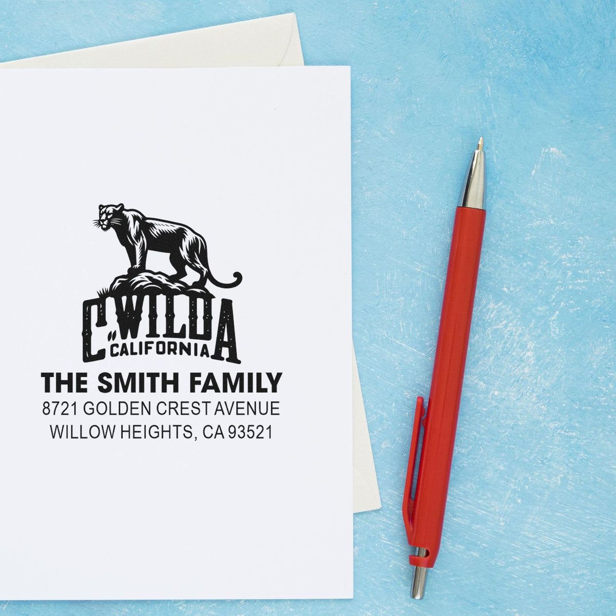 Personalized address rubber stamp with panther design for The Smith Family, shown on a white envelope.
