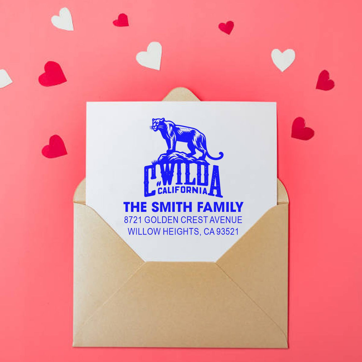 Custom return address rubber stamp on envelope with family name, California panther design, and mailing address.