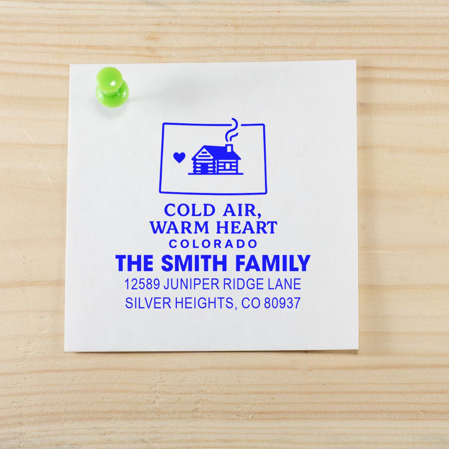 Custom rubber address stamp for The Smith Family, featuring Colorado cabin logo and return address in blue ink.
