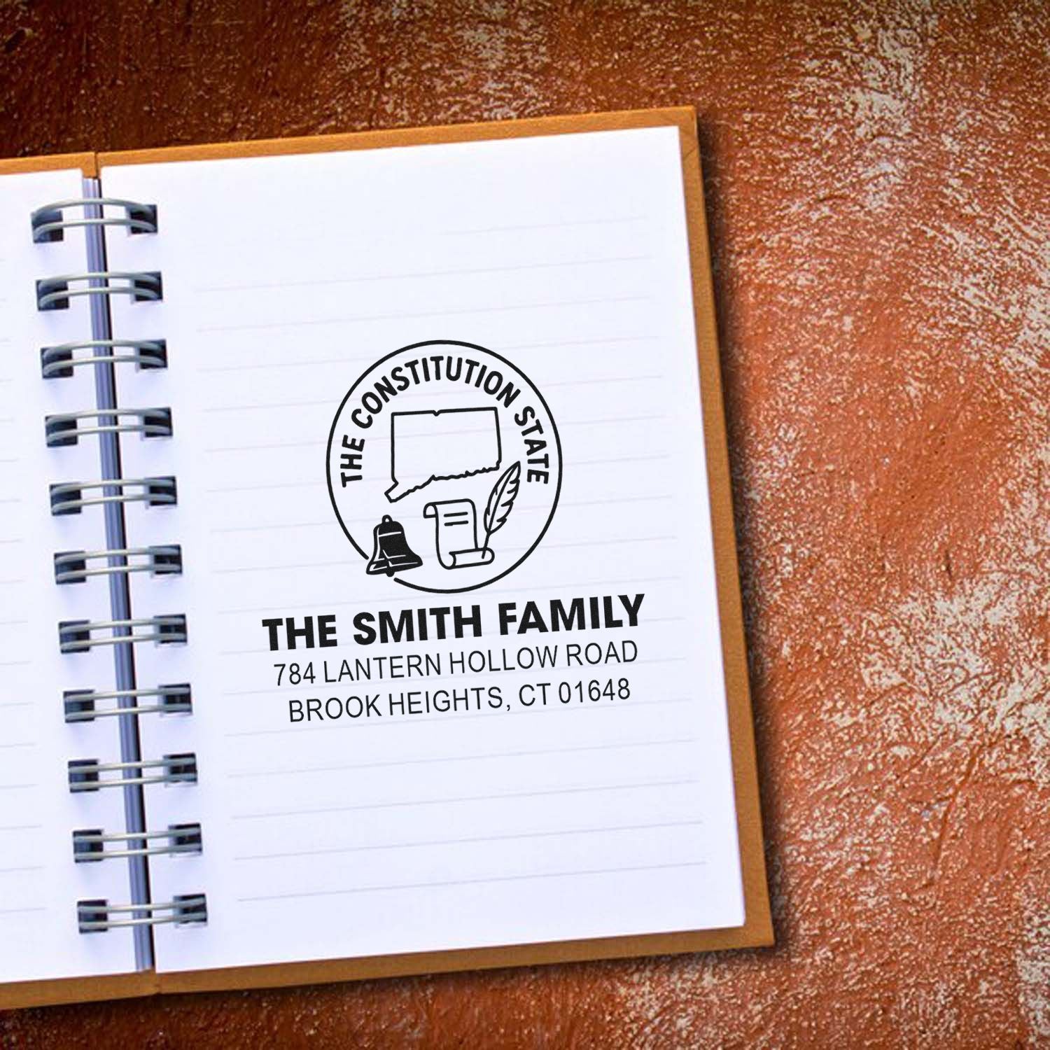 Custom rubber address stamp for The Smith Family, featuring Connecticut state logo and return address on a notebook.