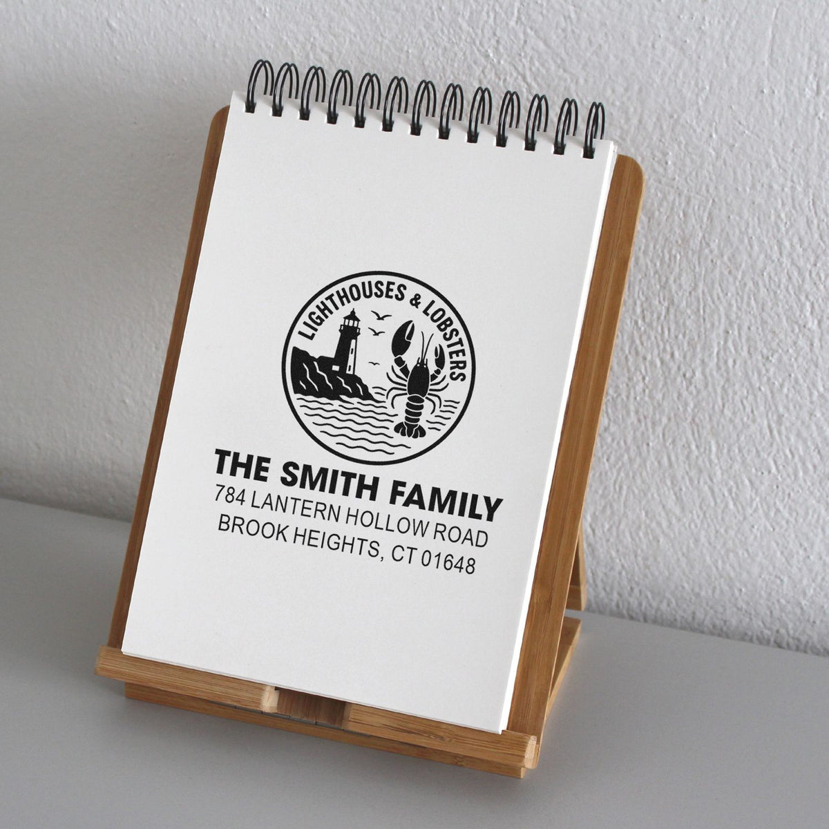 Custom address rubber stamp with lighthouse and lobster logo for The Smith Family, ideal for coastal return address stamping.