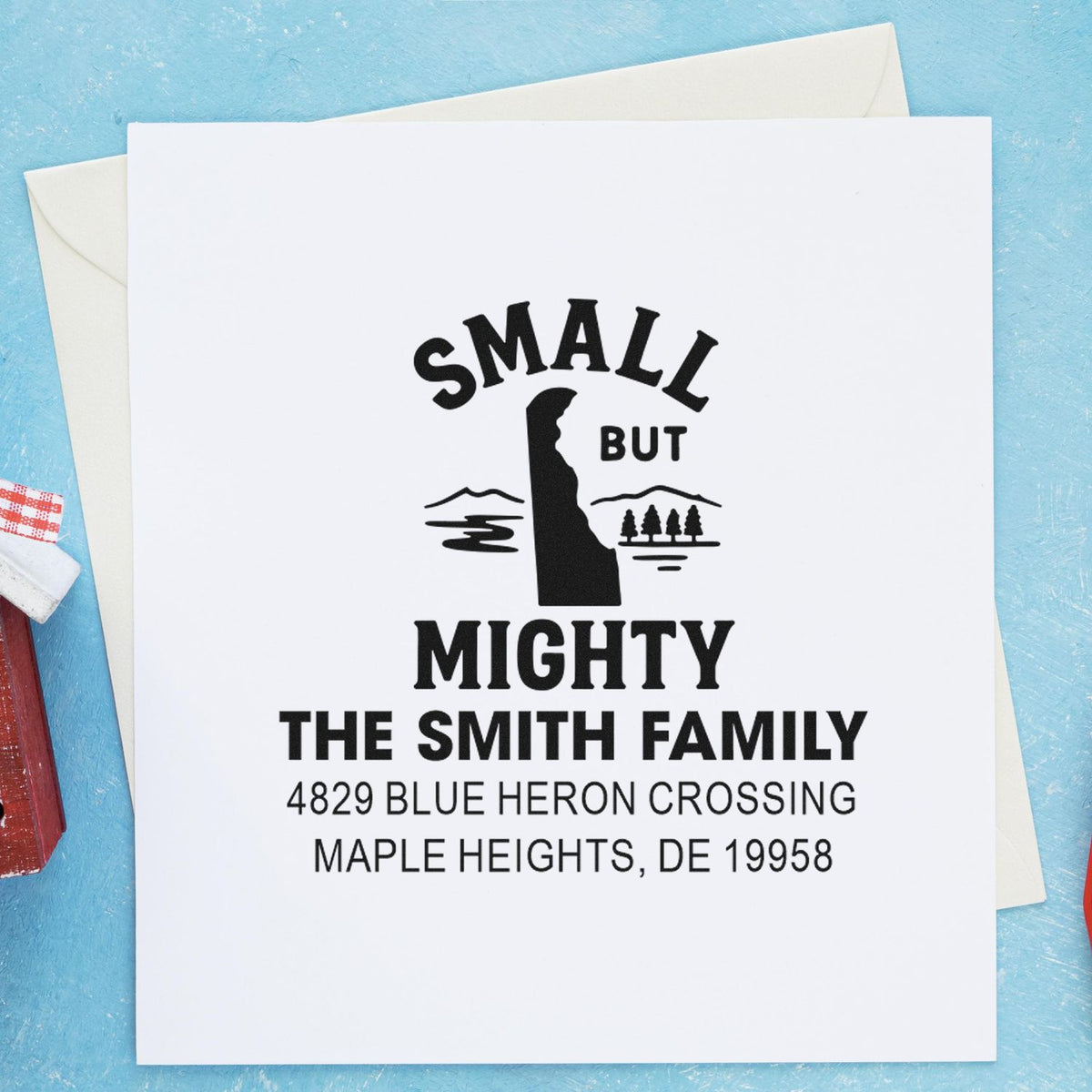 Custom return address rubber stamp on greeting card, featuring the "Small But Mighty" Smith family design and address.