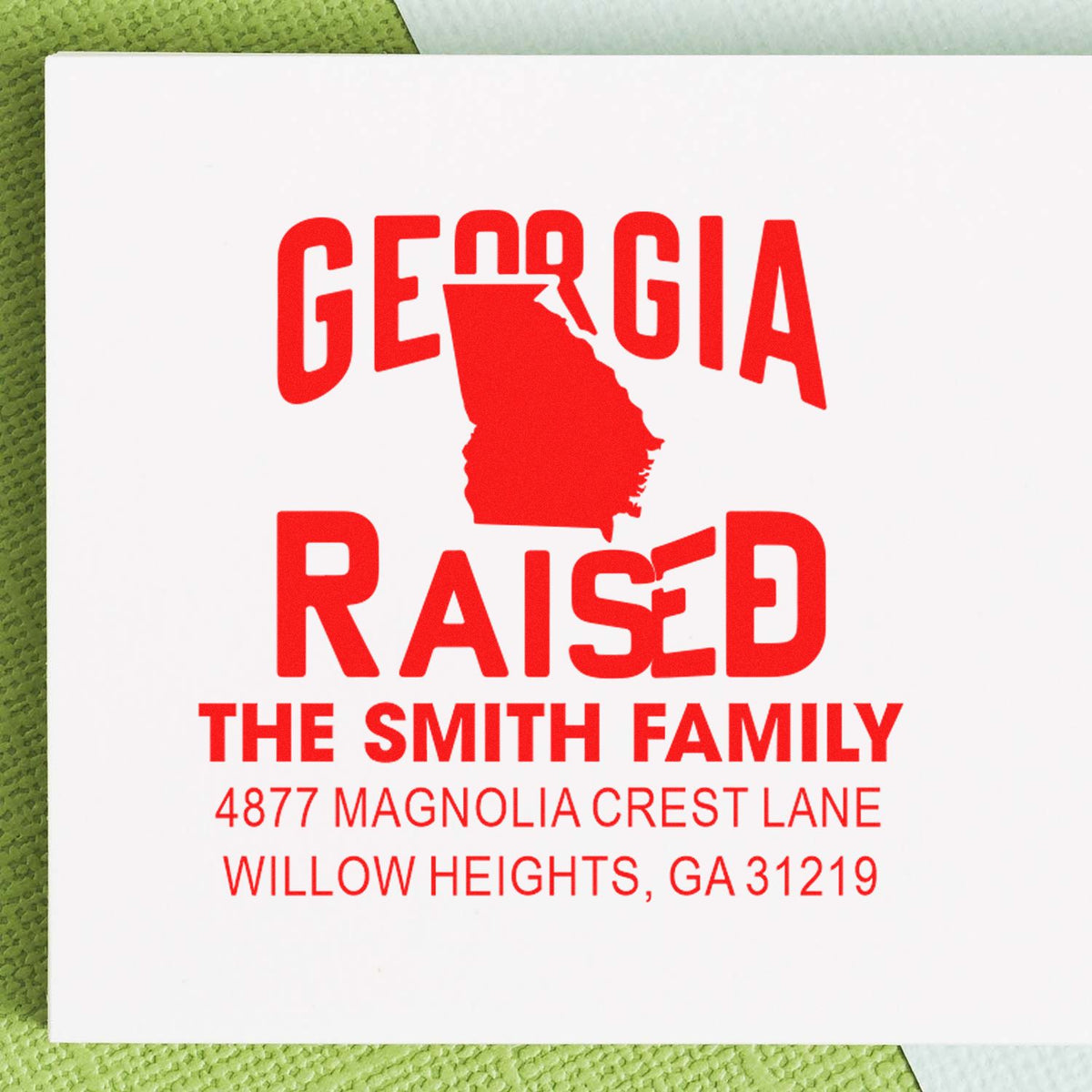 Georgia Raised custom rubber stamp with family name, Georgia state silhouette, and return address for Willow Heights, GA.